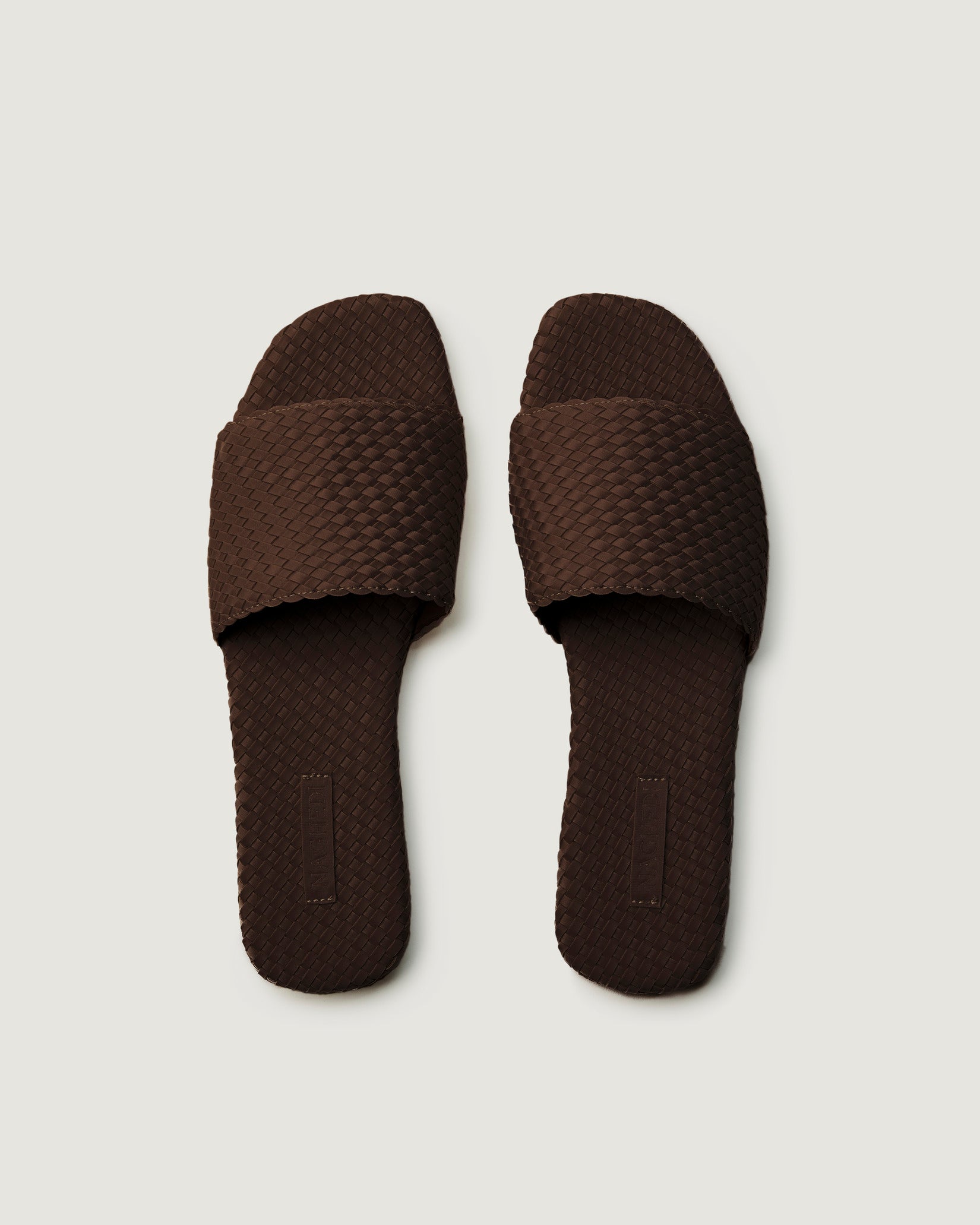 Top view of pair of St. Barths Slide Sandals in Chocolate showing the handwoven neoprene insole.