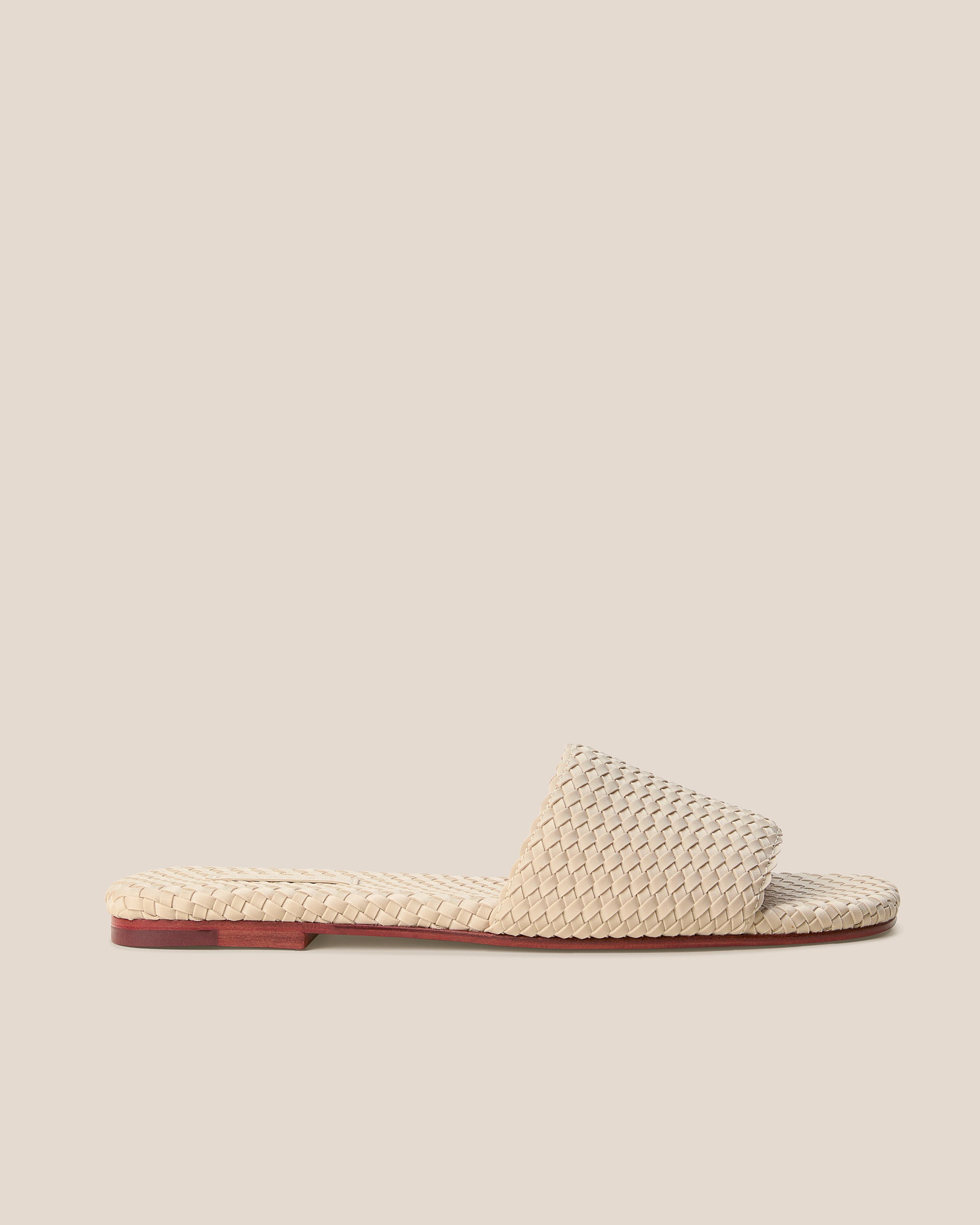 Side view of St. Barths Slide Sandals in Ecru, a cream tone, featuring an open toe and square silhouette.