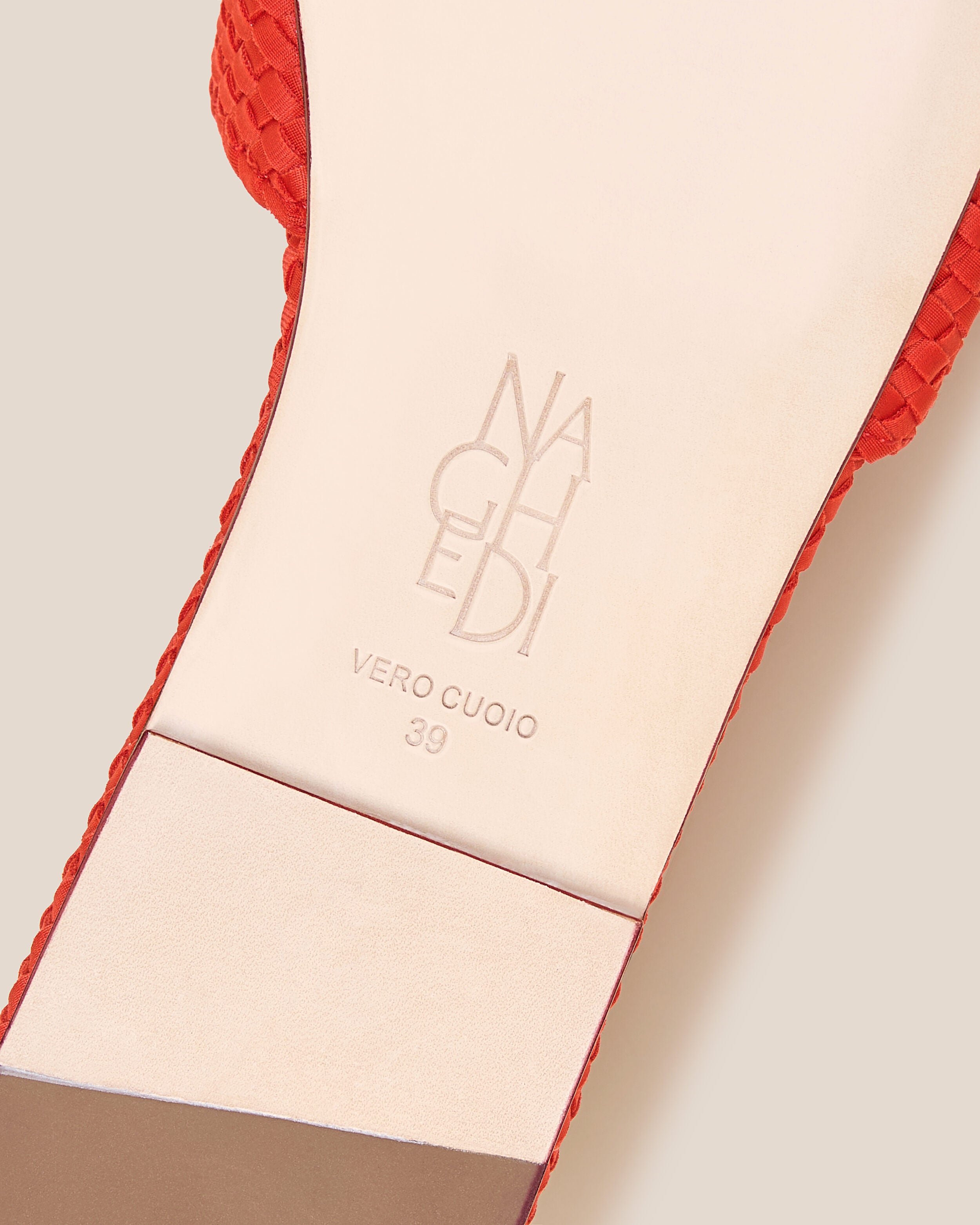 Shoe sole showing natural buffed leather sole, stamped NAGHEDI logo and size detail for The St. Barths Slide in Ipanema.