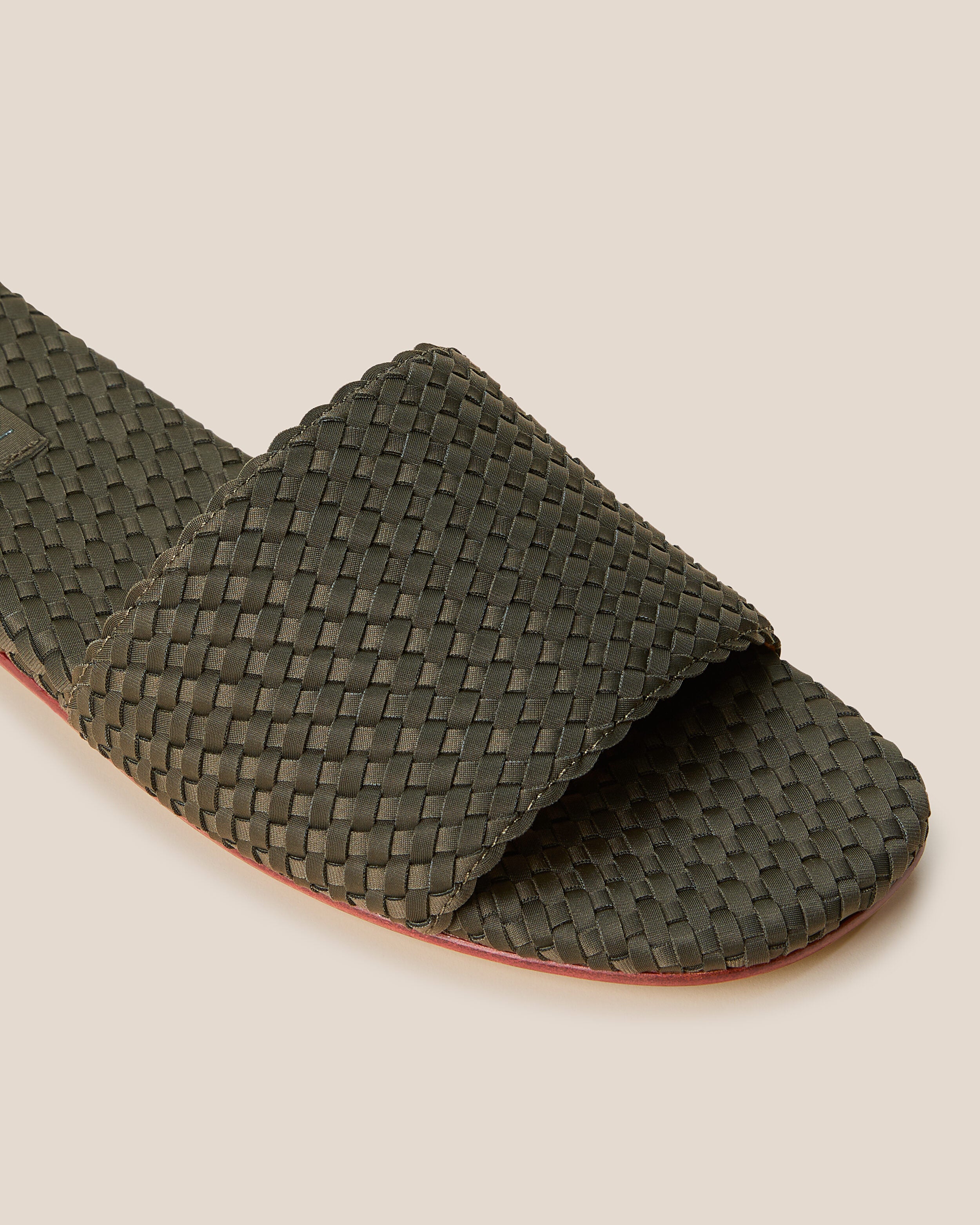 Close-up of The St. Barths Slide in Olive showing its open toe and square silhouette.