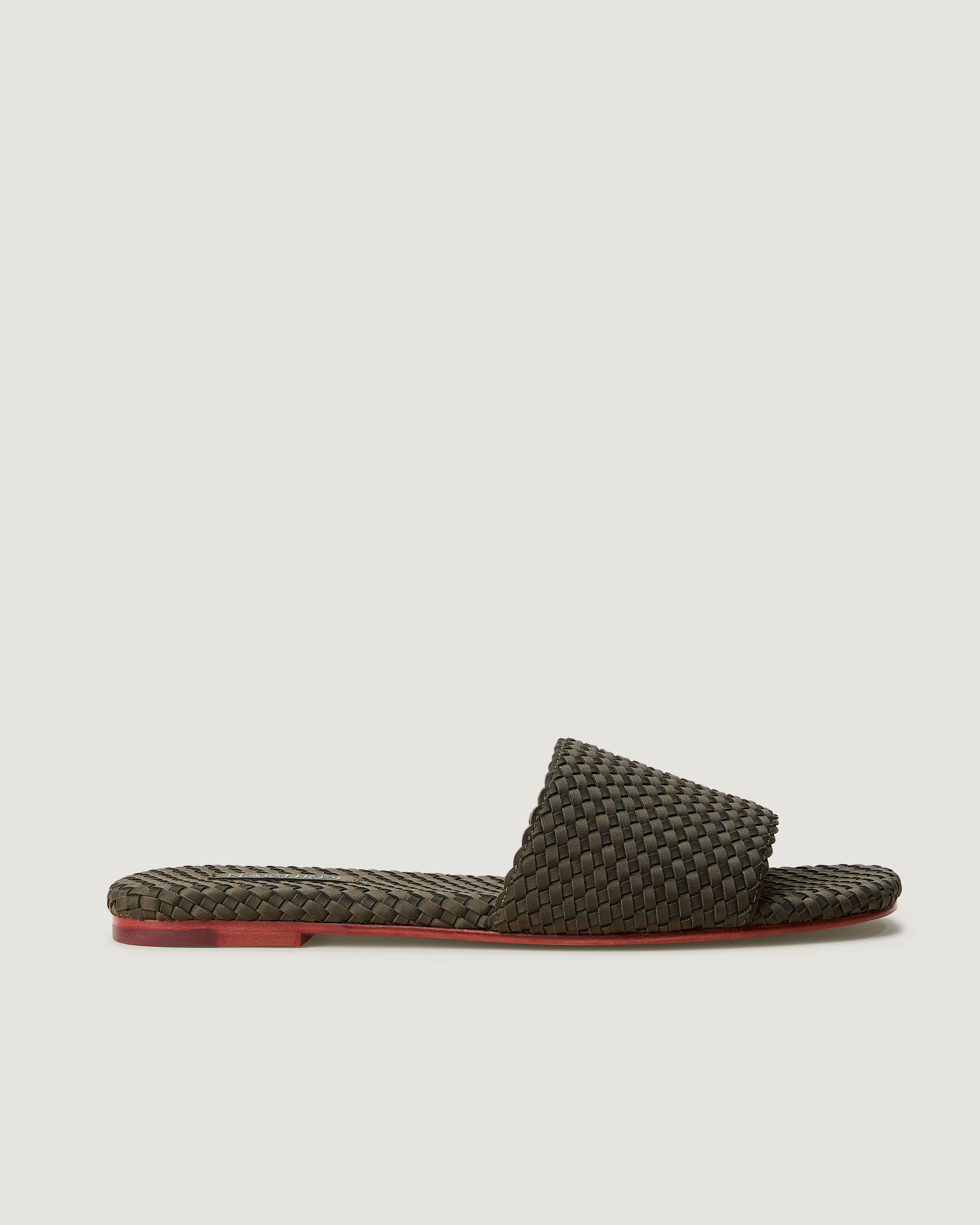 Side view of The St. Barths Slide in Olive, an olive green tone, featuring an open toe and square silhouette.