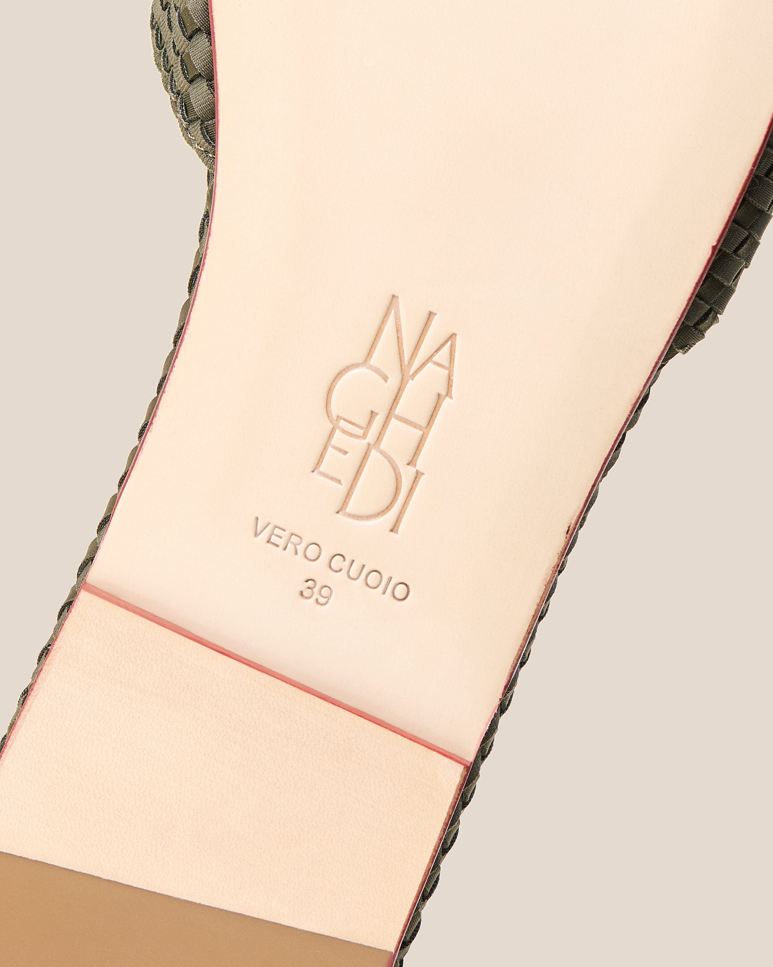 Shoe sole showing natural buffed leather sole, stamped NAGHEDI logo and size detail for The St. Barths Slide in Olive.