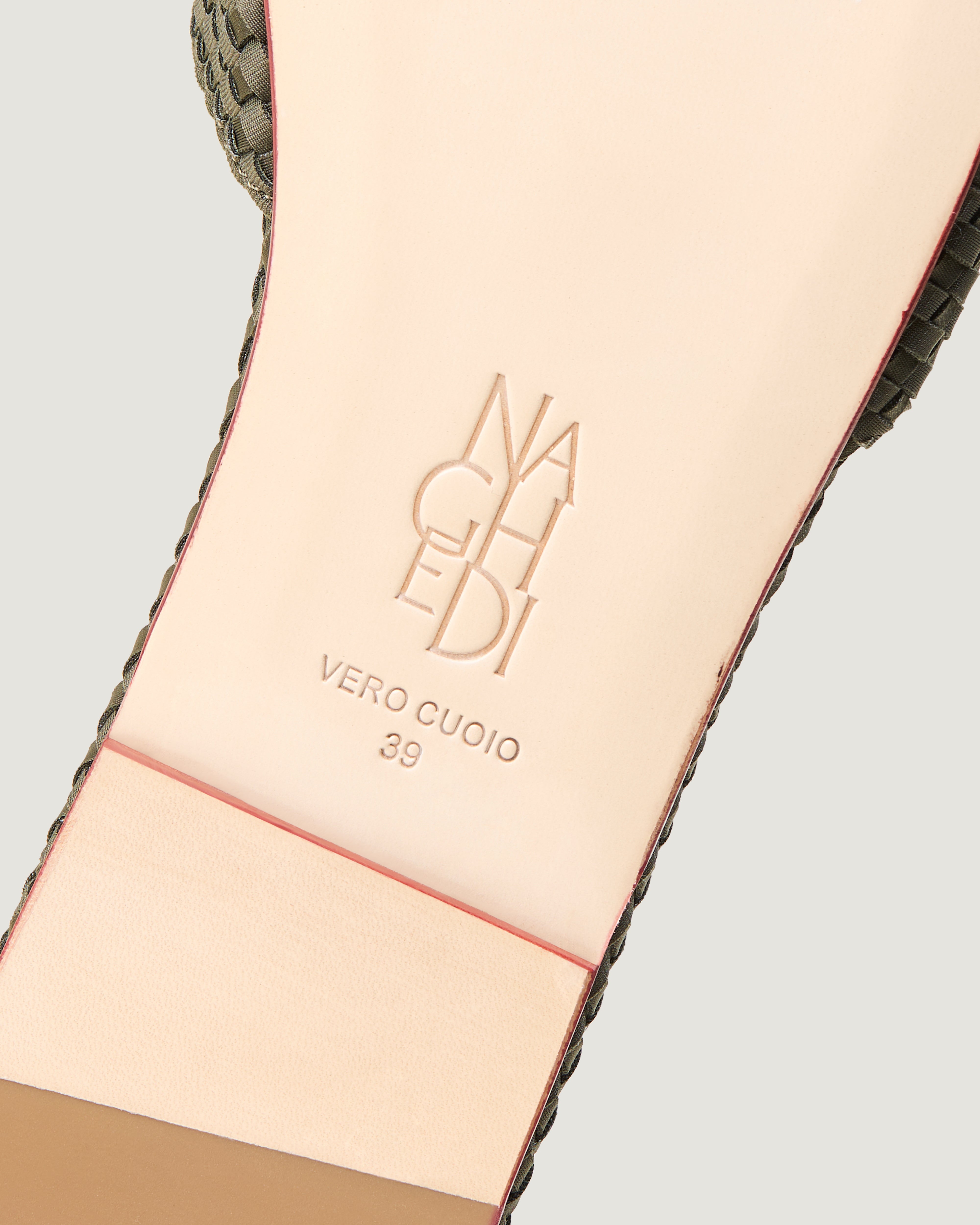 Shoe sole showing natural buffed leather sole, stamped NAGHEDI logo and size detail for The St. Barths Slide in Olive.
