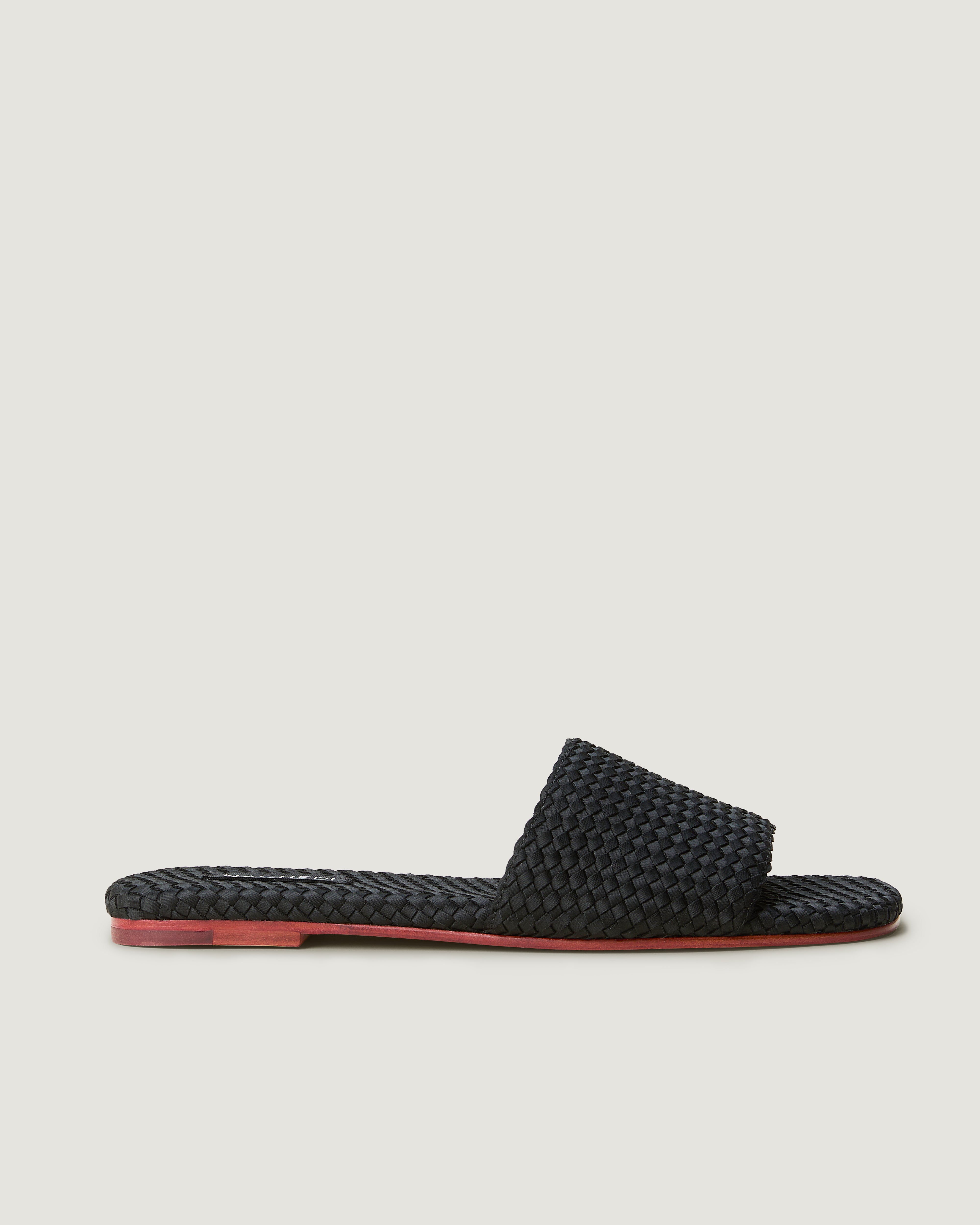 Side view of The St. Barths Slide in Onyx, a true black tone, featuring an open toe and square silhouette.