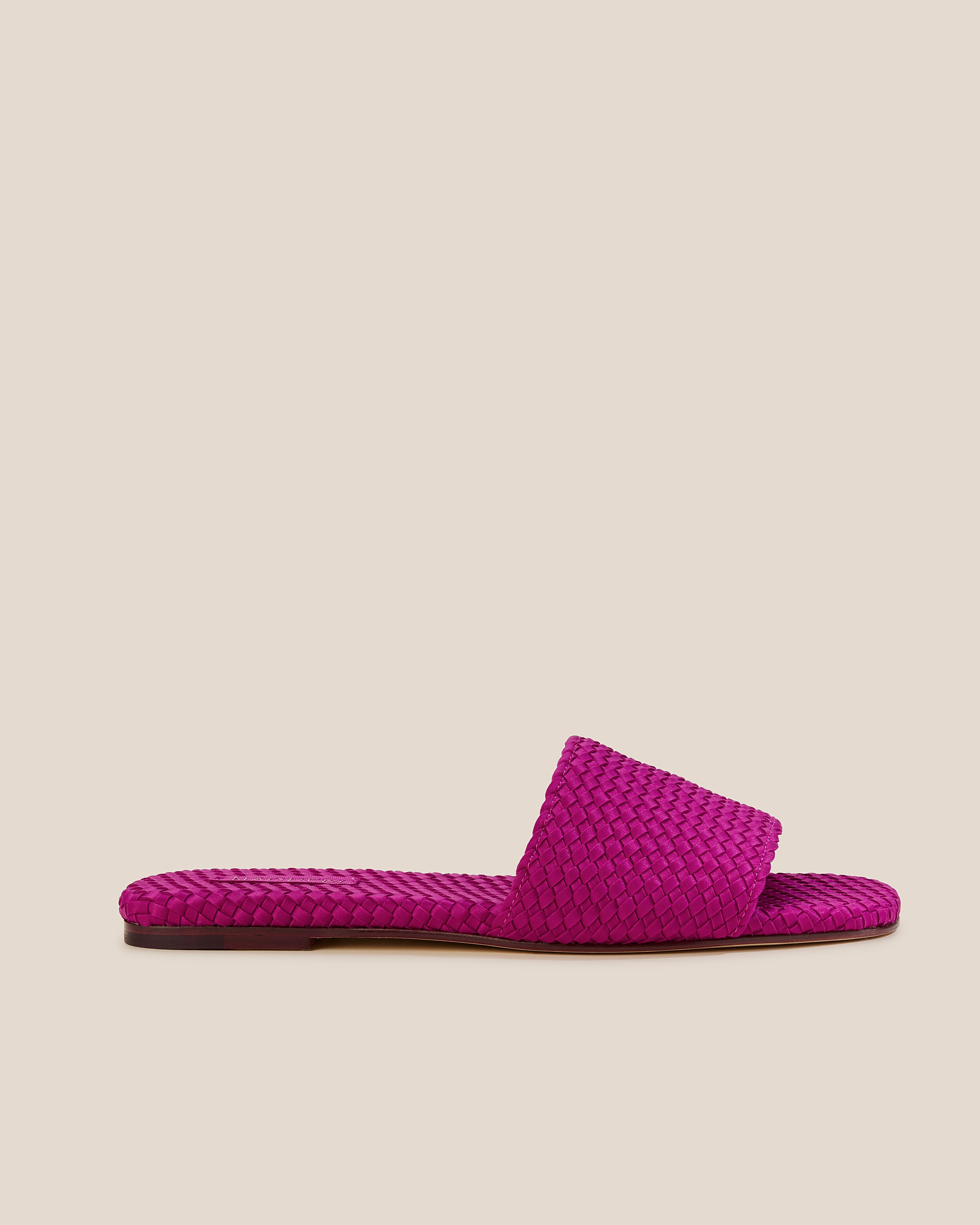 Side view of The St. Barths Slide in Rio, a fuchsia tone, featuring an open toe and square silhouette.