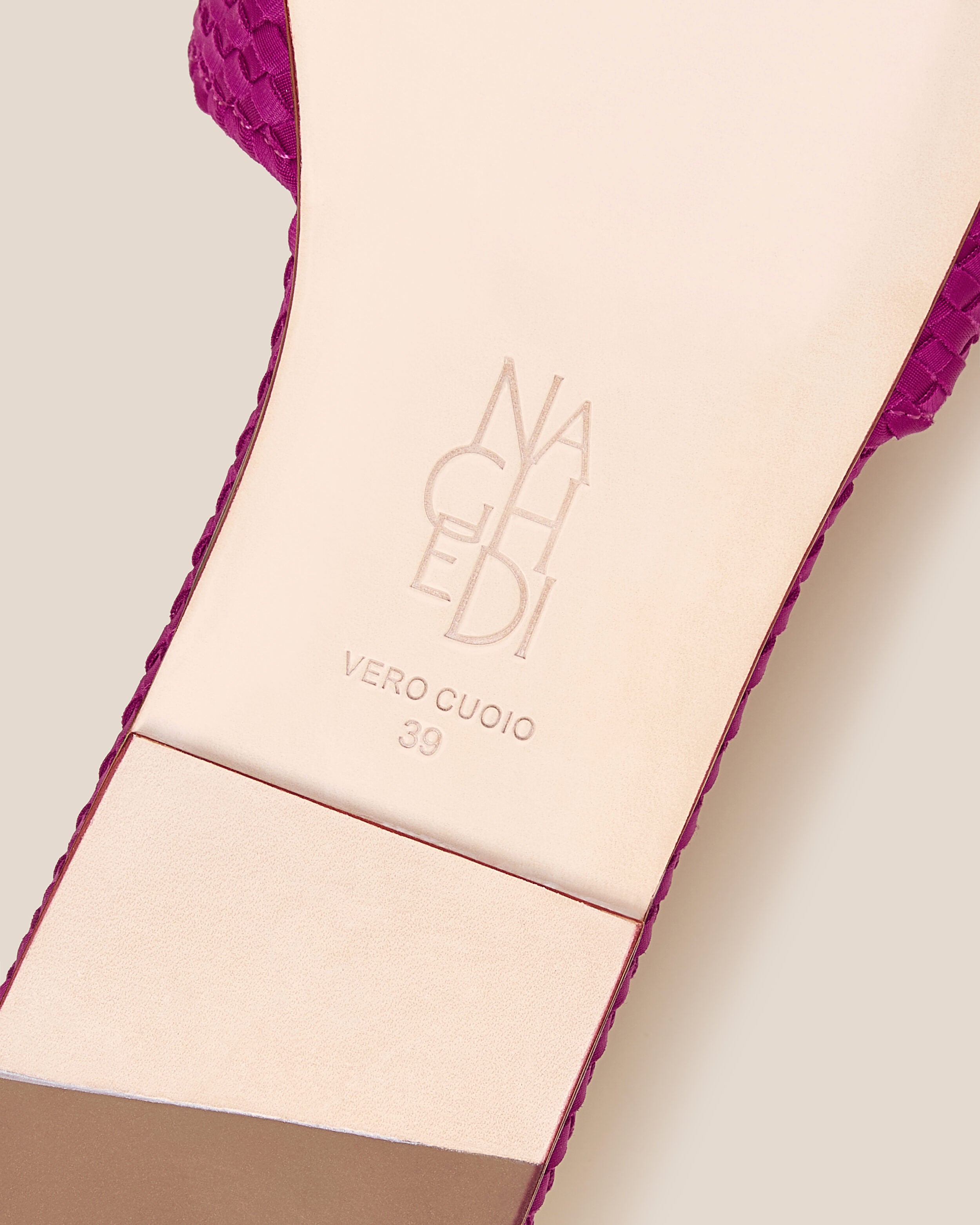 Shoe sole showing natural buffed leather sole, stamped NAGHEDI logo and size detail for The St. Barths Slide in Rio.