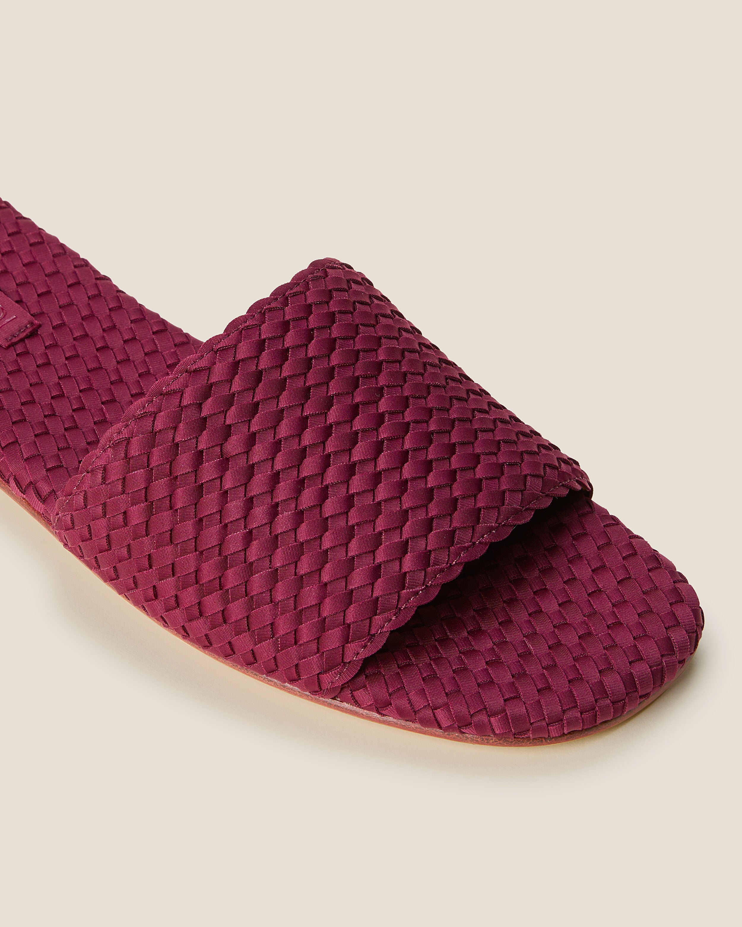 Close-up of The St. Barths Slide in Rosewood showing its open toe and square silhouette.