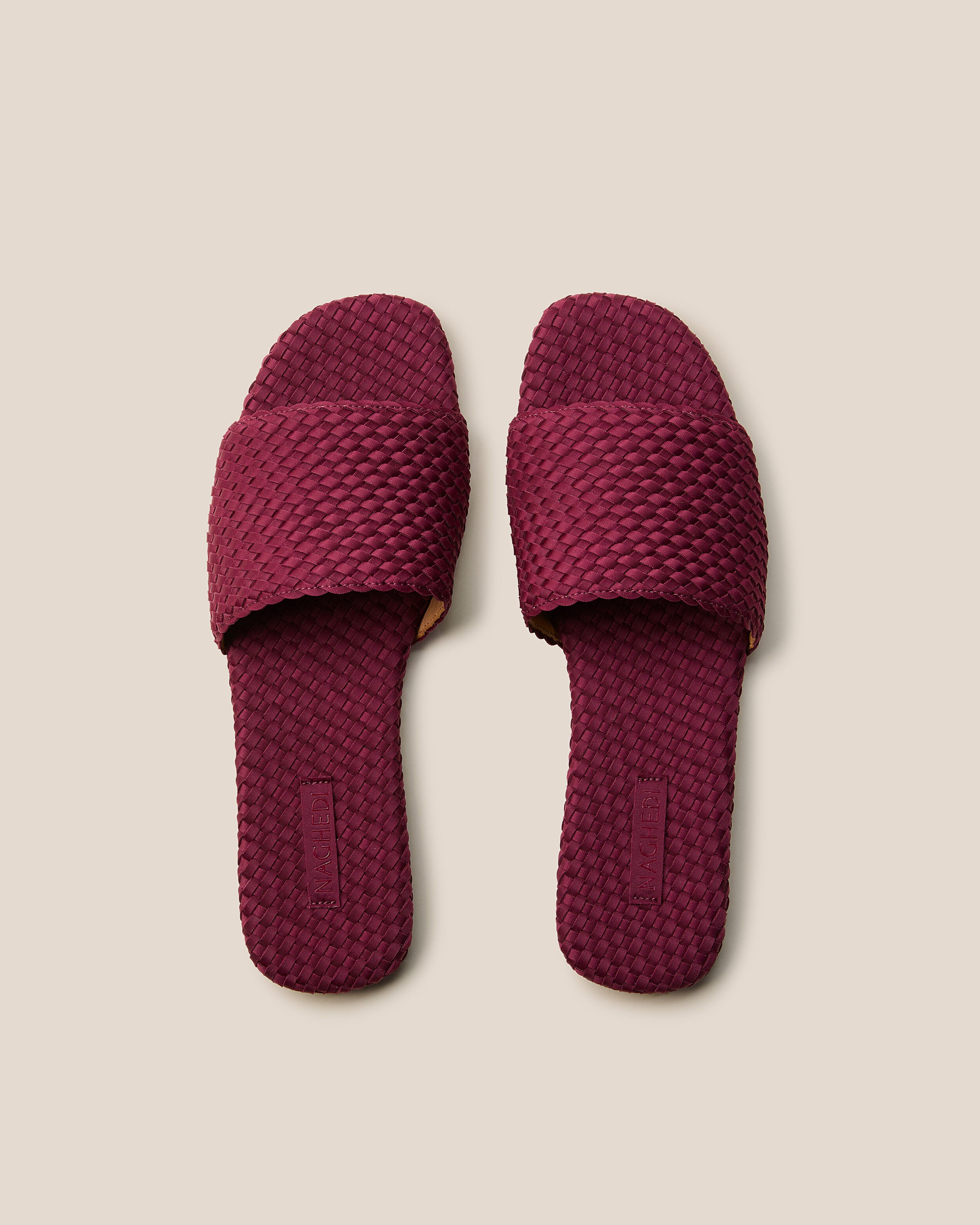 Top view of pair of The St. Barths Slide in Rosewood showing the handwoven neoprene insole.