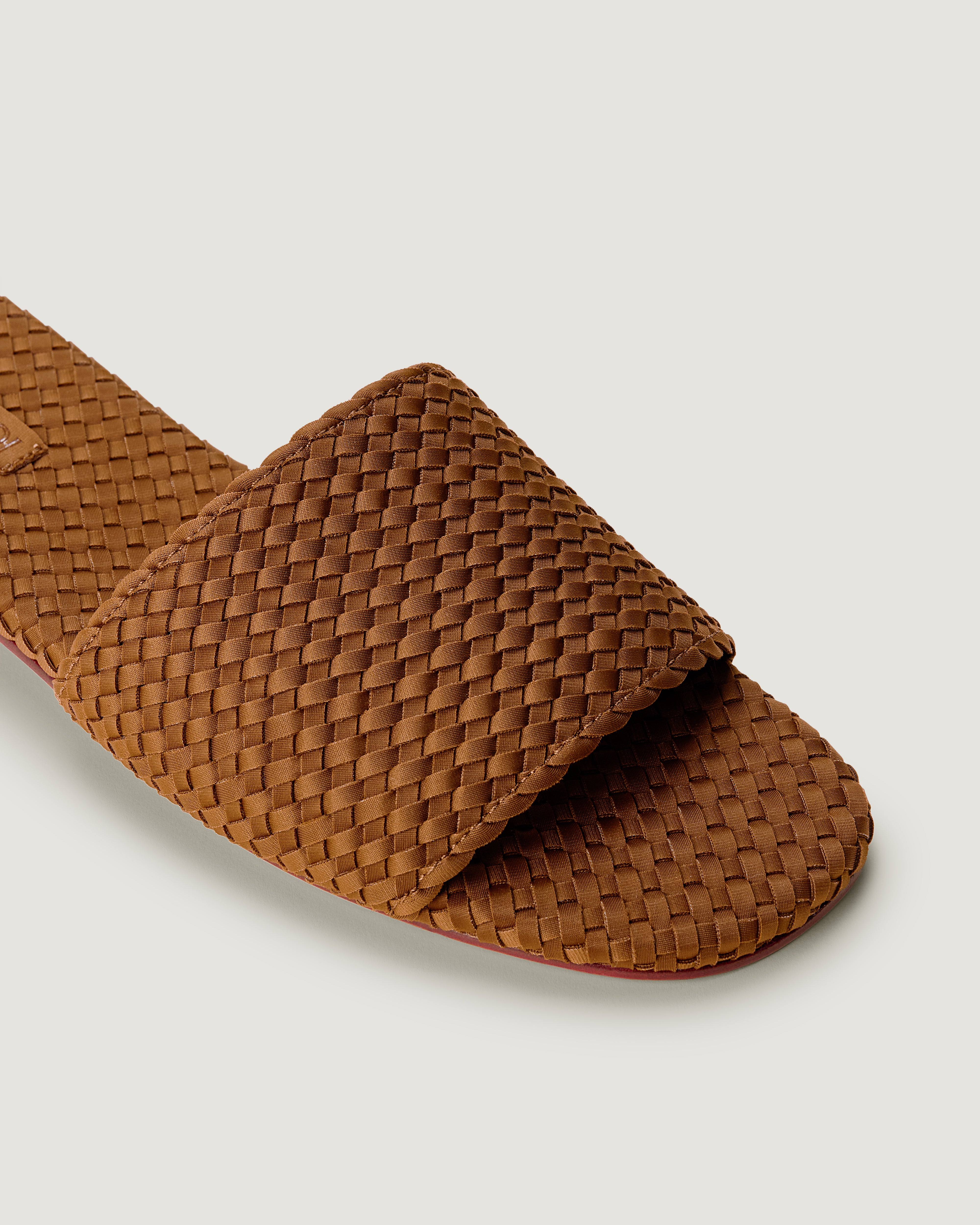 Close-up of The St. Barths Slide in Teak showing its open toe and square silhouette.
