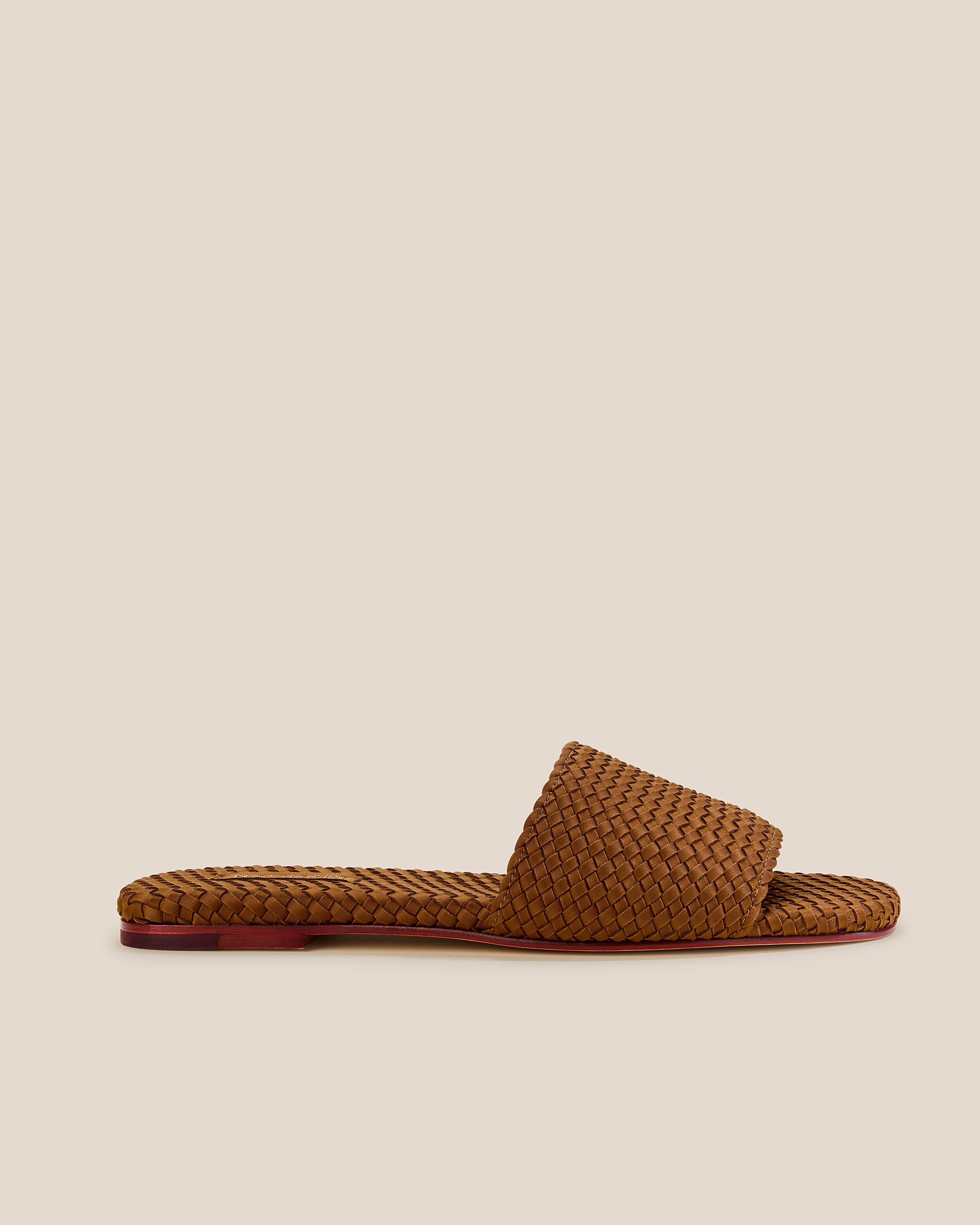Side view of The St. Barths Slide in Teak, a saddle brown tone, featuring an open toe and square silhouette.