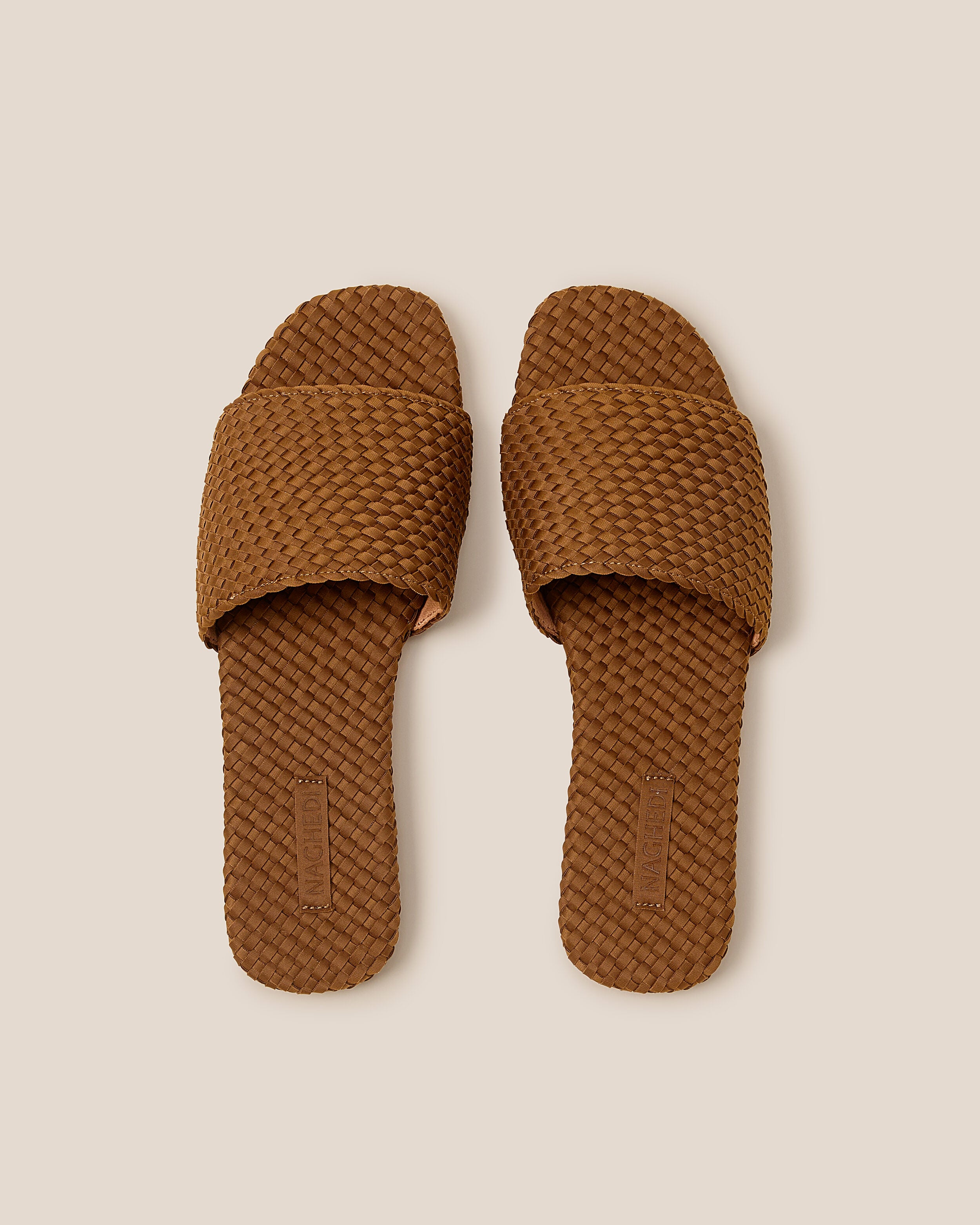 Top view of pair of The St. Barths Slide in Teak showing the handwoven neoprene insole.