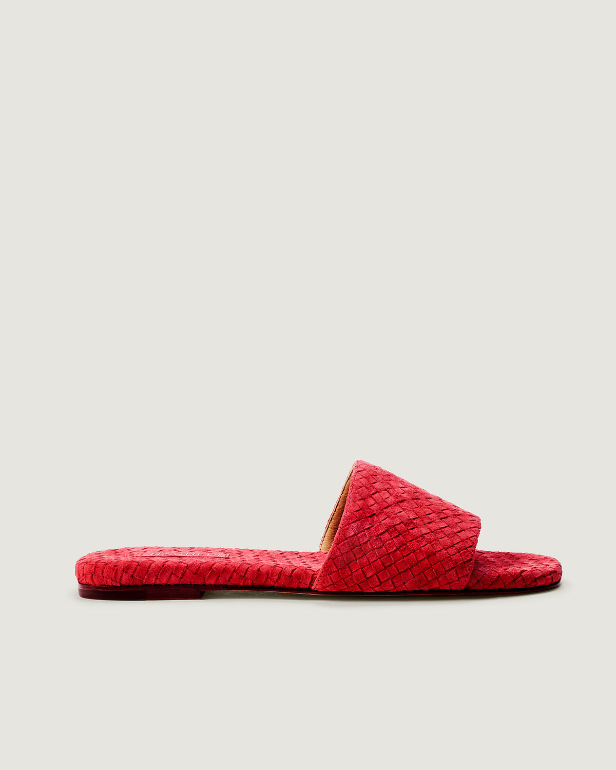 Side view of The St. Barths Slide in Cerise, a bright cherry red tone, featuring an open toe and square silhouette.
