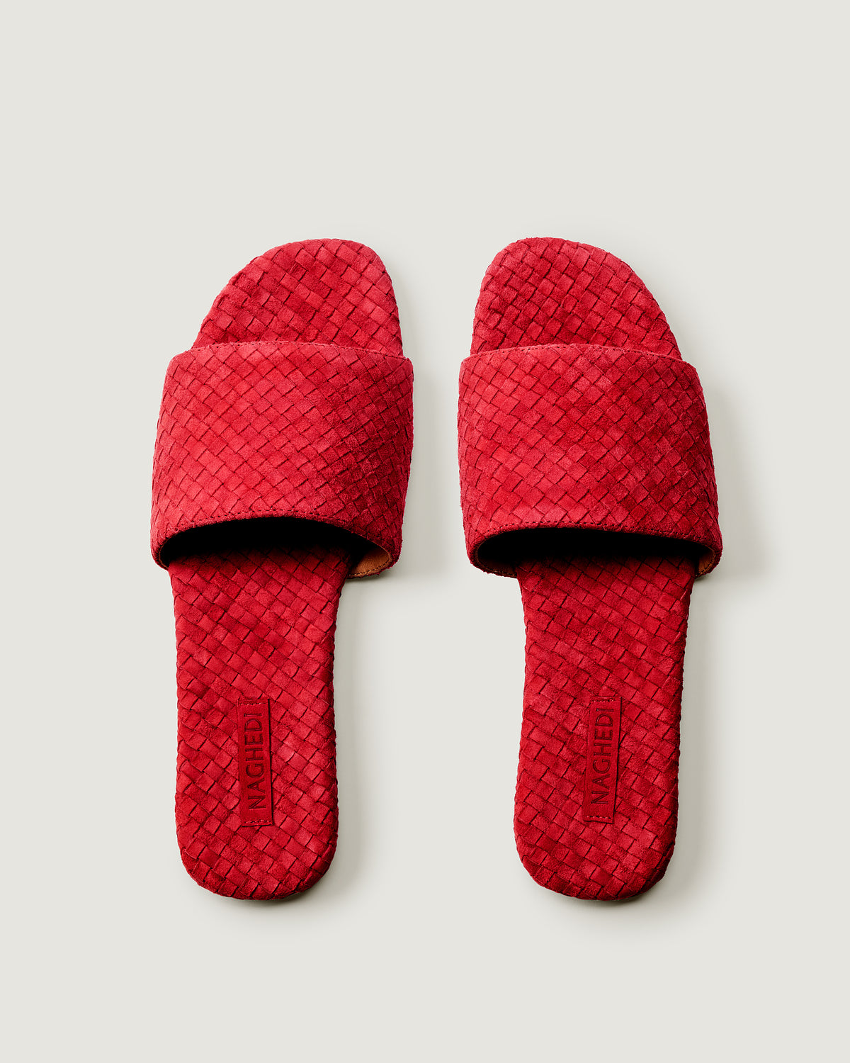 Top view of pair of The St. Barths Slide in Cerise showing the handwoven suede insole.