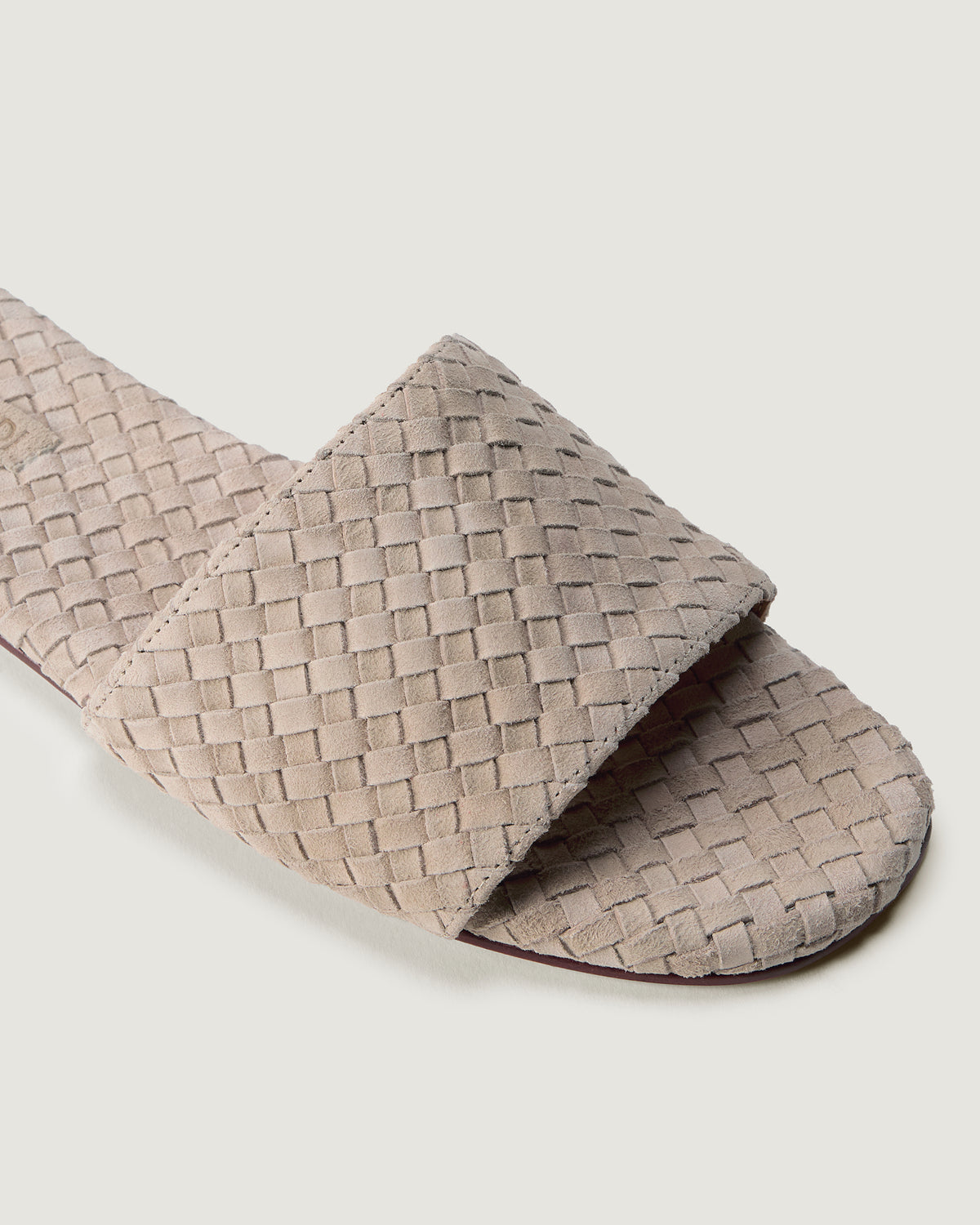 Close-up of The St. Barths Slide in Linen showing its open toe and square silhouette.
