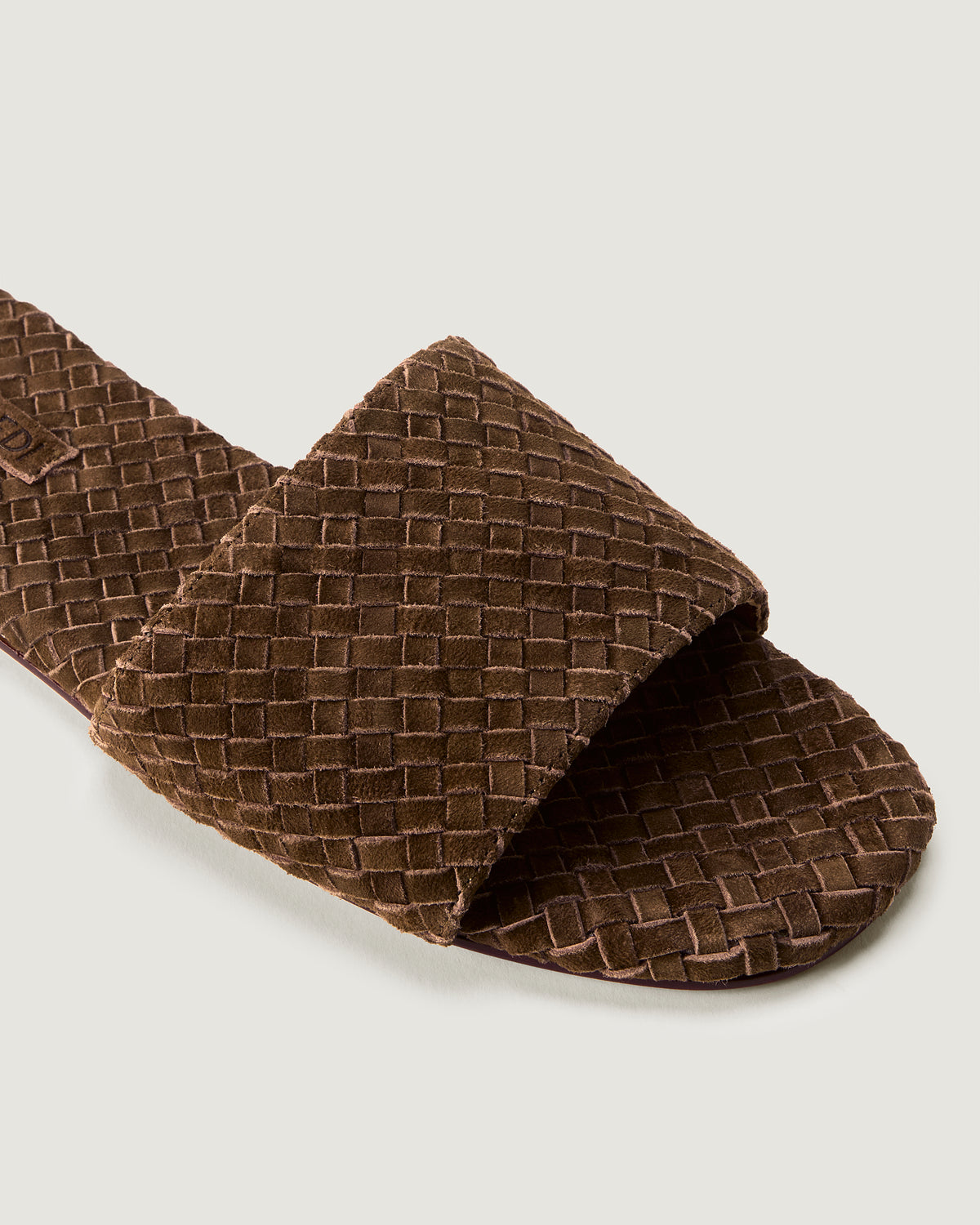 Close-up of The St. Barths Slide in Teak showing its open toe and square silhouette.