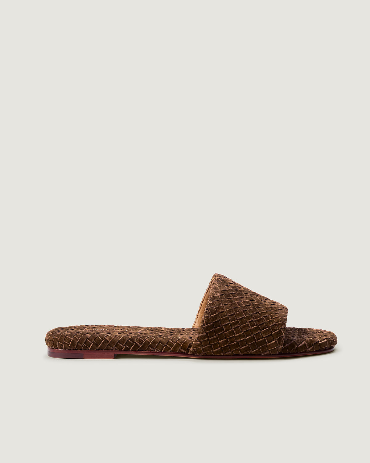 Side view of The St. Barths Slide in Teak, a saddle brown tone, featuring an open toe and square silhouette.