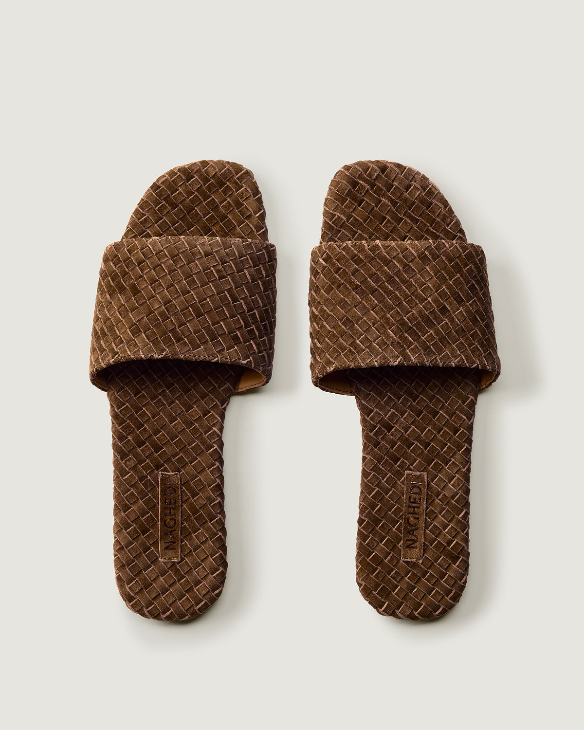 Top view of pair of The St. Barths Slide in Teak showing the handwoven suede insole.