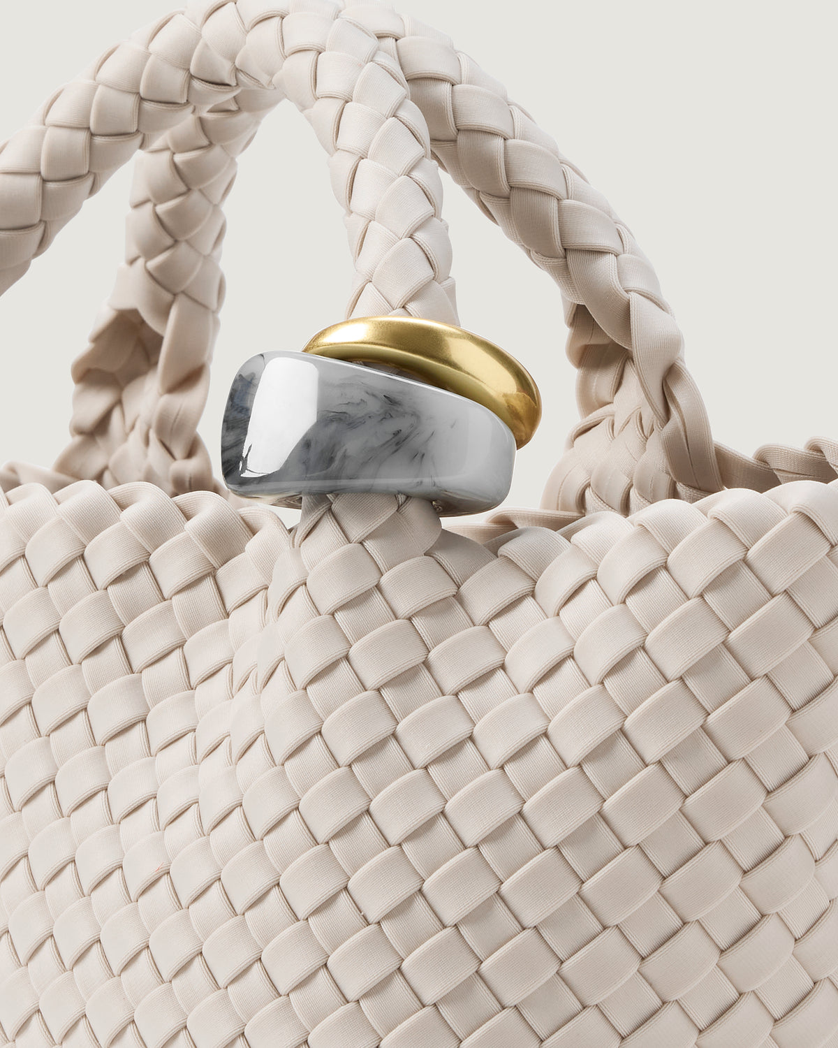 Close up of the St Barths Tote in Linen highlighting the two beads on the handle.