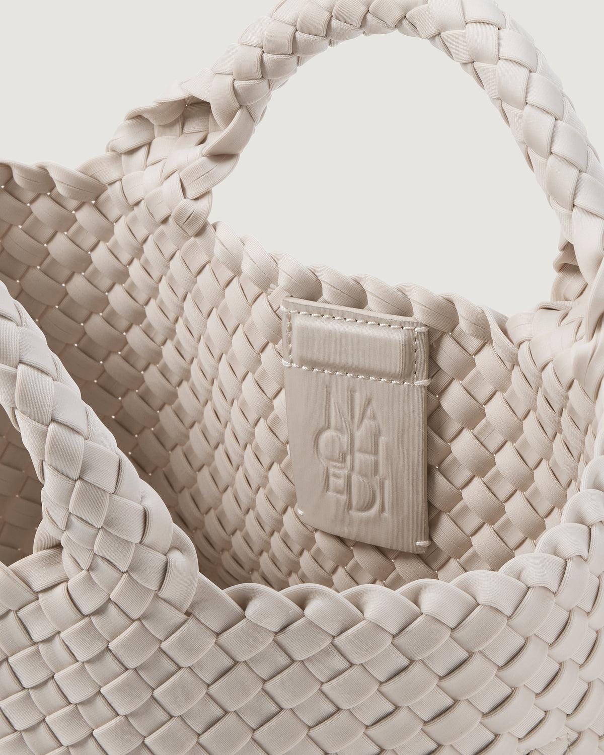 Interior close up of the St Barths Tote in Ivory showing open top, unlined interior, and magnetic closure.