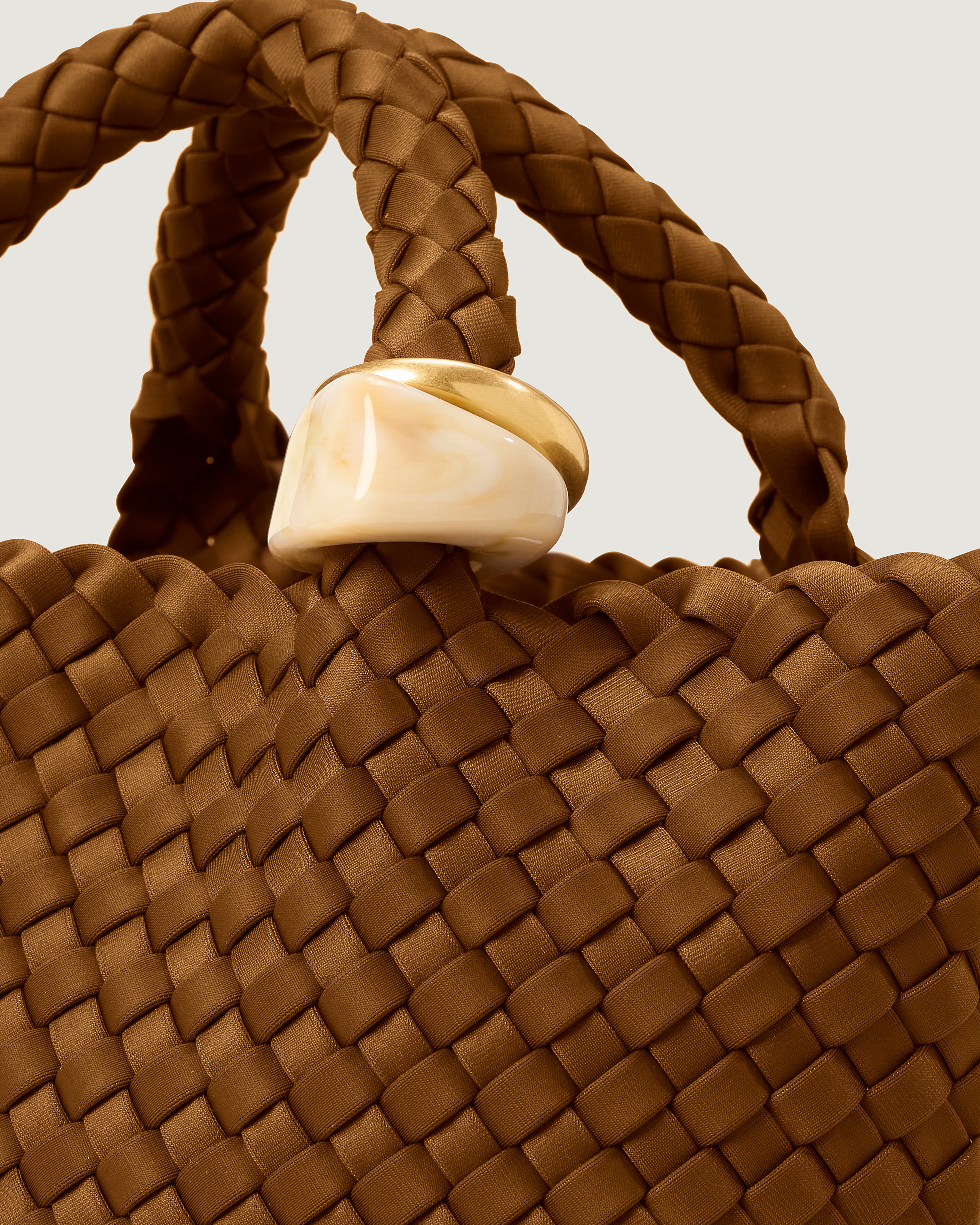 Close up of the St Barths Tote in Teak highlighting the 2 beads on the handle.