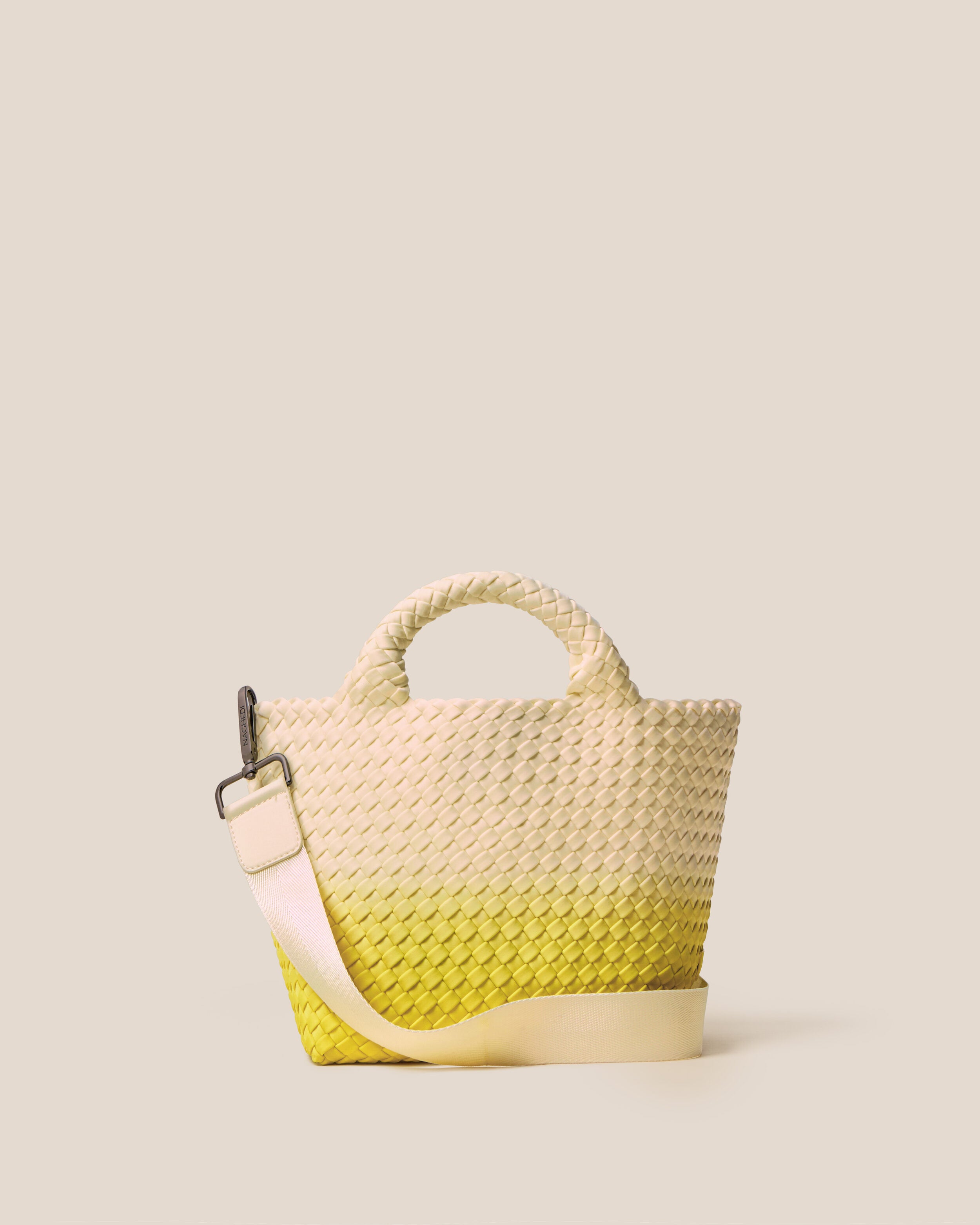 St. Barths Tote in Ginkgo, a bone and yellow tone, in handwoven neoprene, featuring an open top, woven top handles, and detachable, adjustable nylon crossbody strap.