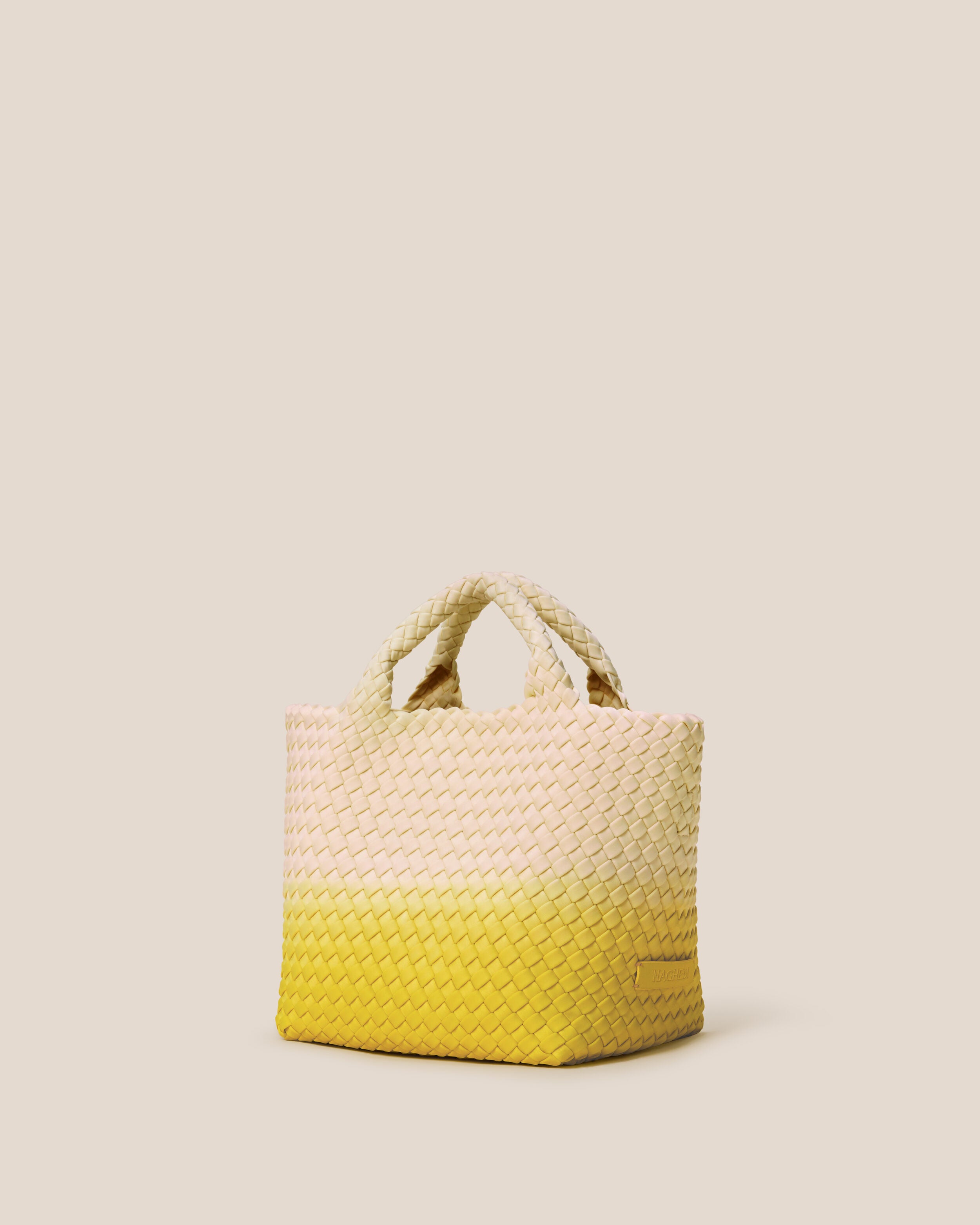 St. Barths Tote in Ginkgo shown from a side angle, highlighting its handwoven neoprene construction and open top.