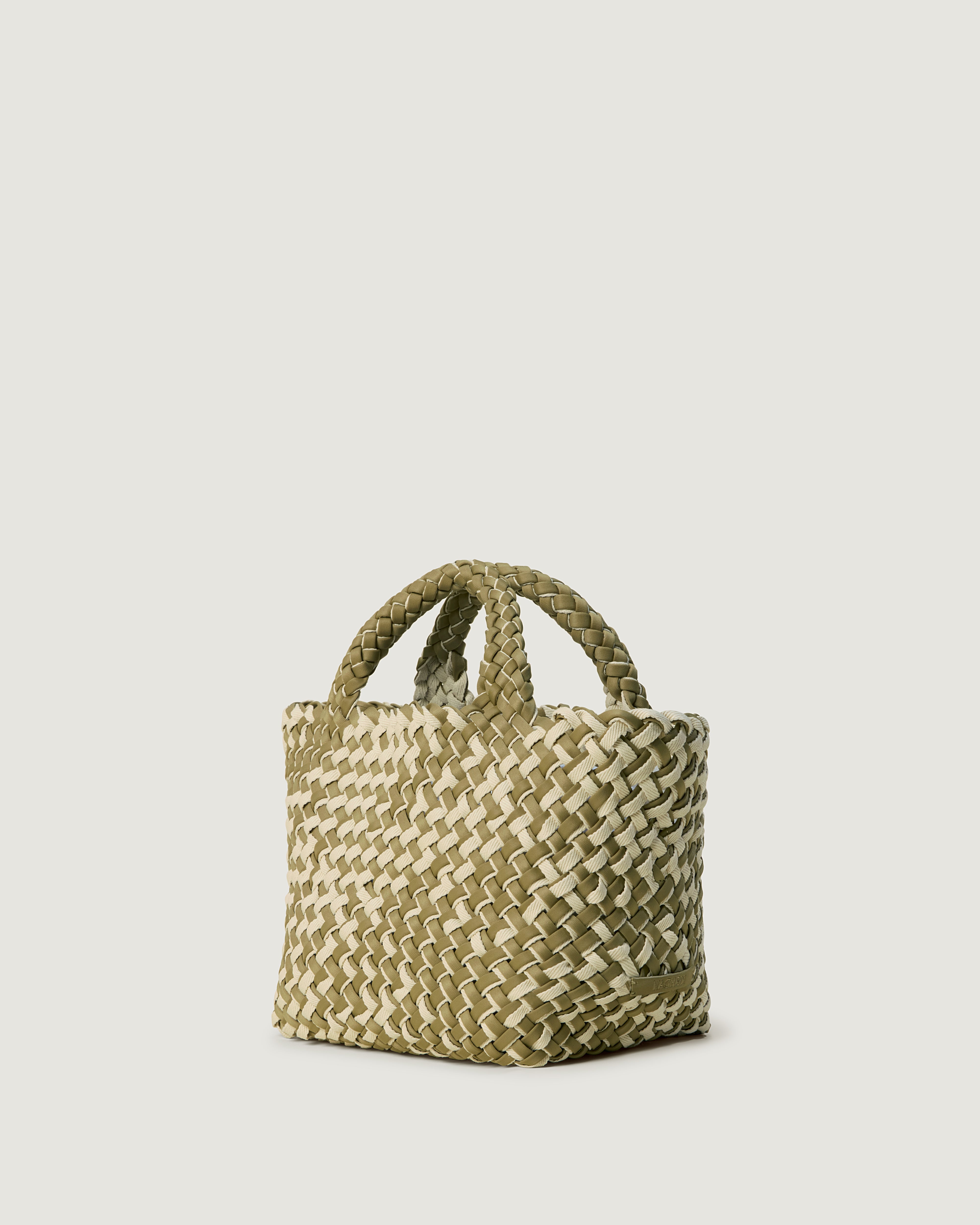 St. Barths Tote in Oletta shown from a side angle, highlighting its handwoven neoprene construction and open top.