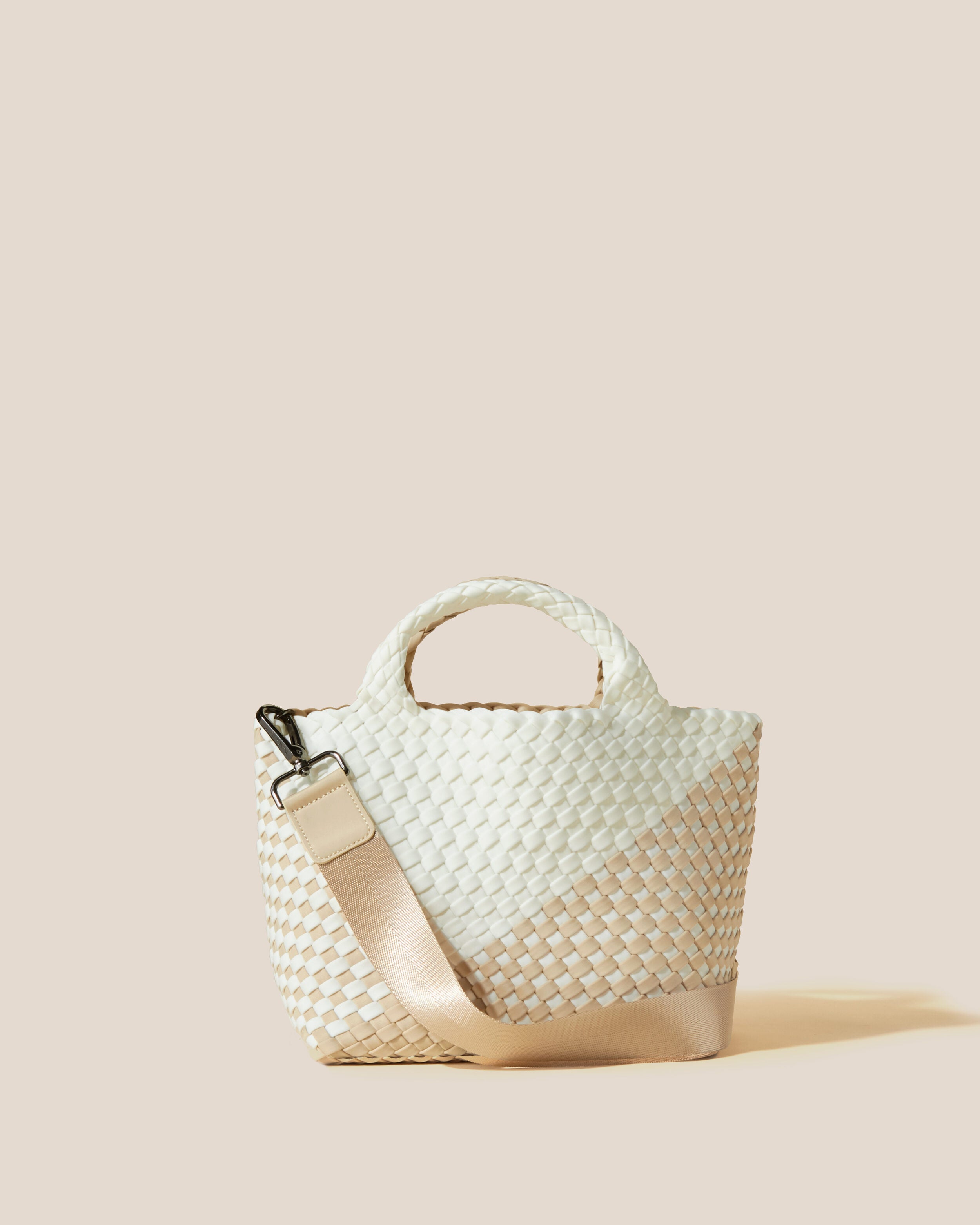 St. Barths Tote in Athena, a white and cream tone, in handwoven neoprene, featuring an open top, woven top handles, and detachable, adjustable nylon crossbody strap.