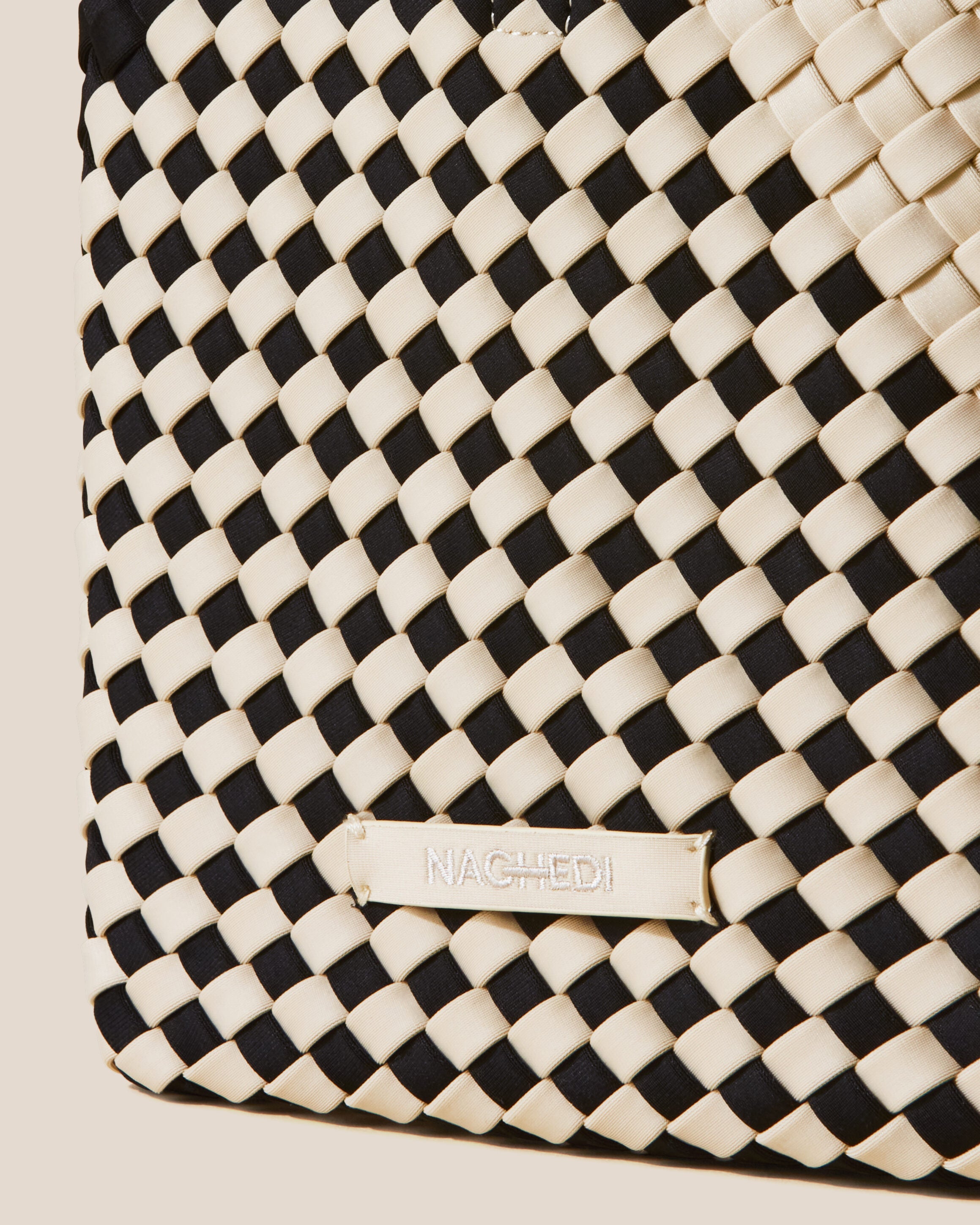 Close-up of stamped NAGHEDI logo on St. Barths Tote in Indio.