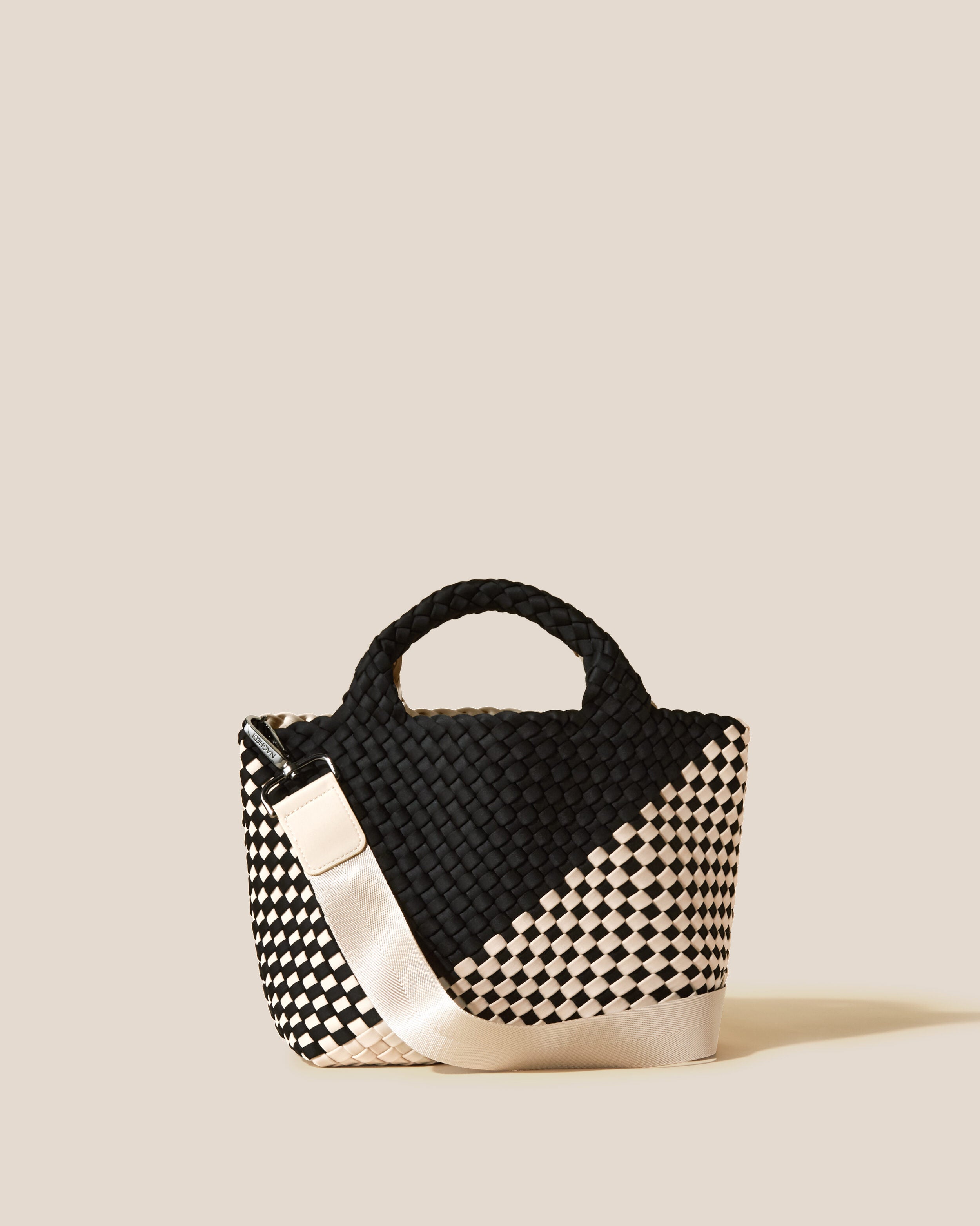 St. Barths Tote in Indio, a cream and true black tone, in handwoven neoprene, featuring an open top, woven top handles, and detachable, adjustable nylon crossbody strap.
