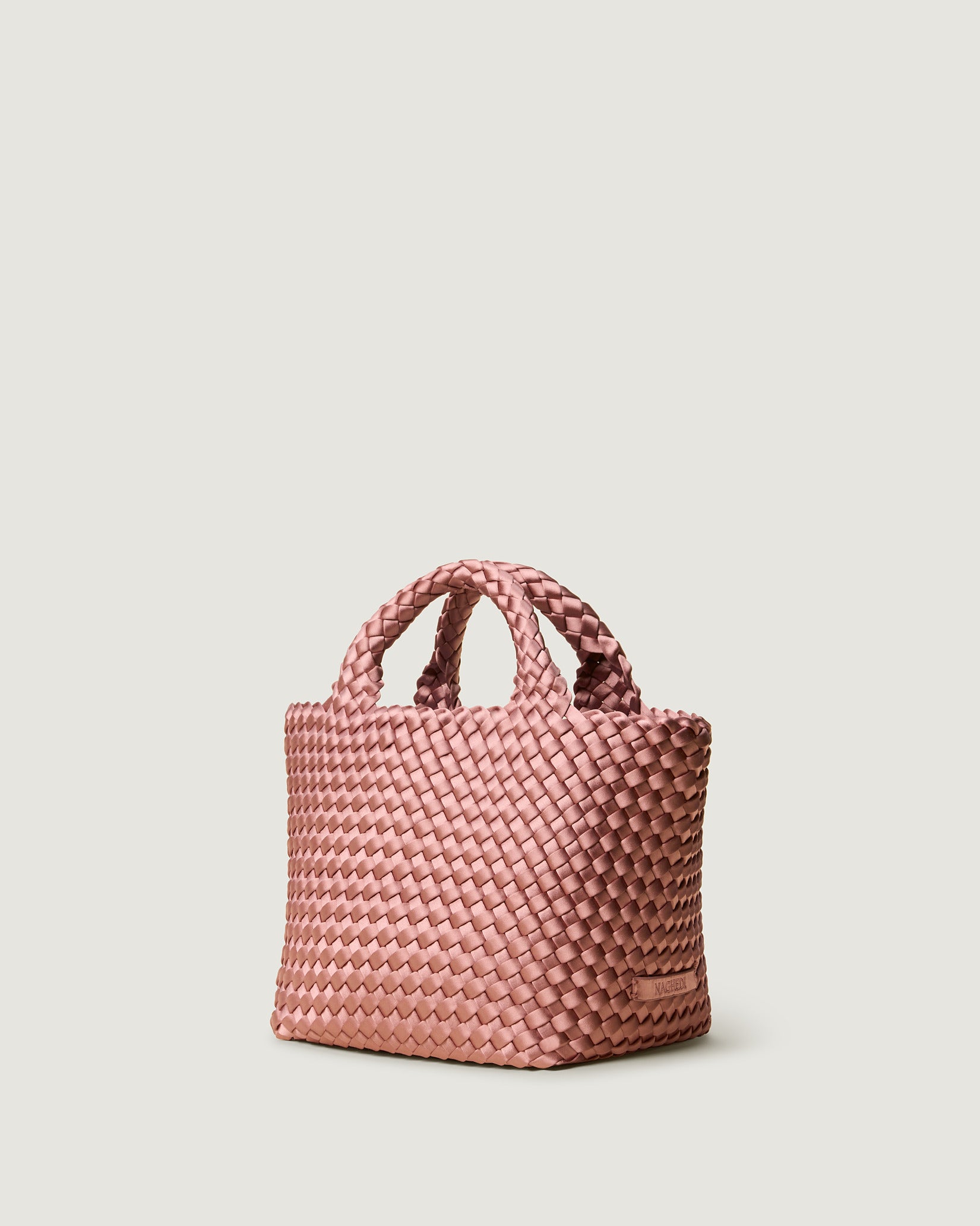 St. Barths Small Satin Tote Bag in Daphne shown from a side angle, highlighting its handwoven neoprene and open top.