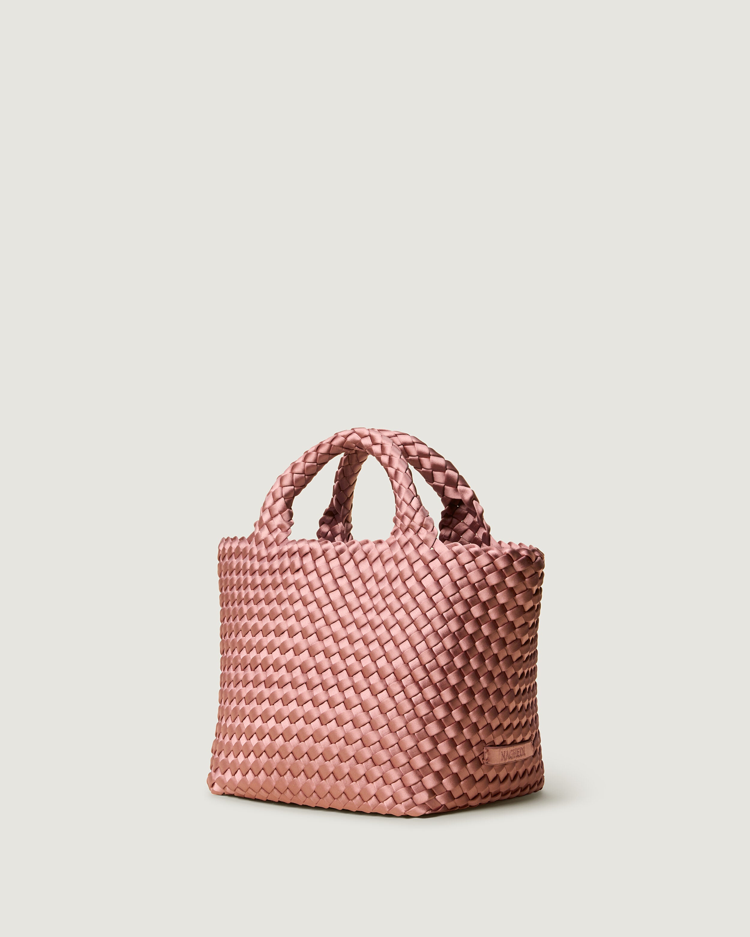 St. Barths Tote in Daphne shown from a side angle, highlighting its handwoven neoprene construction and open top.
