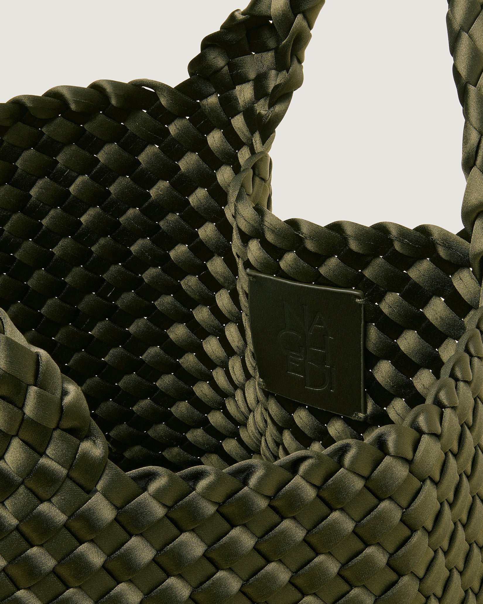Interior close-up of St. Barths Small Satin Tote Bag in Juniper showing its open top, and unlined interior.