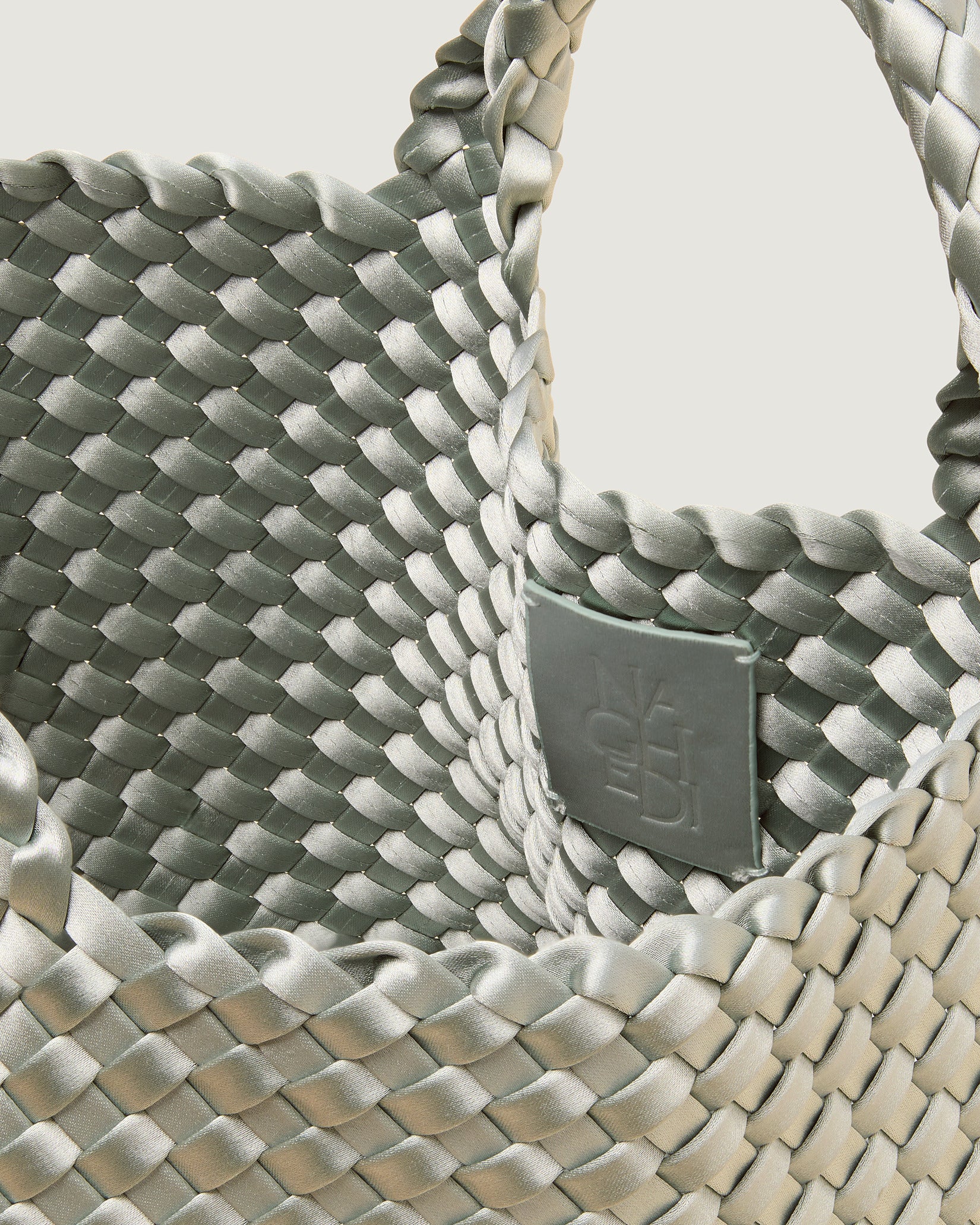 Interior close-up of St. Barths Small Satin Tote Bag in Wintergreen showing its open top, and unlined interior.