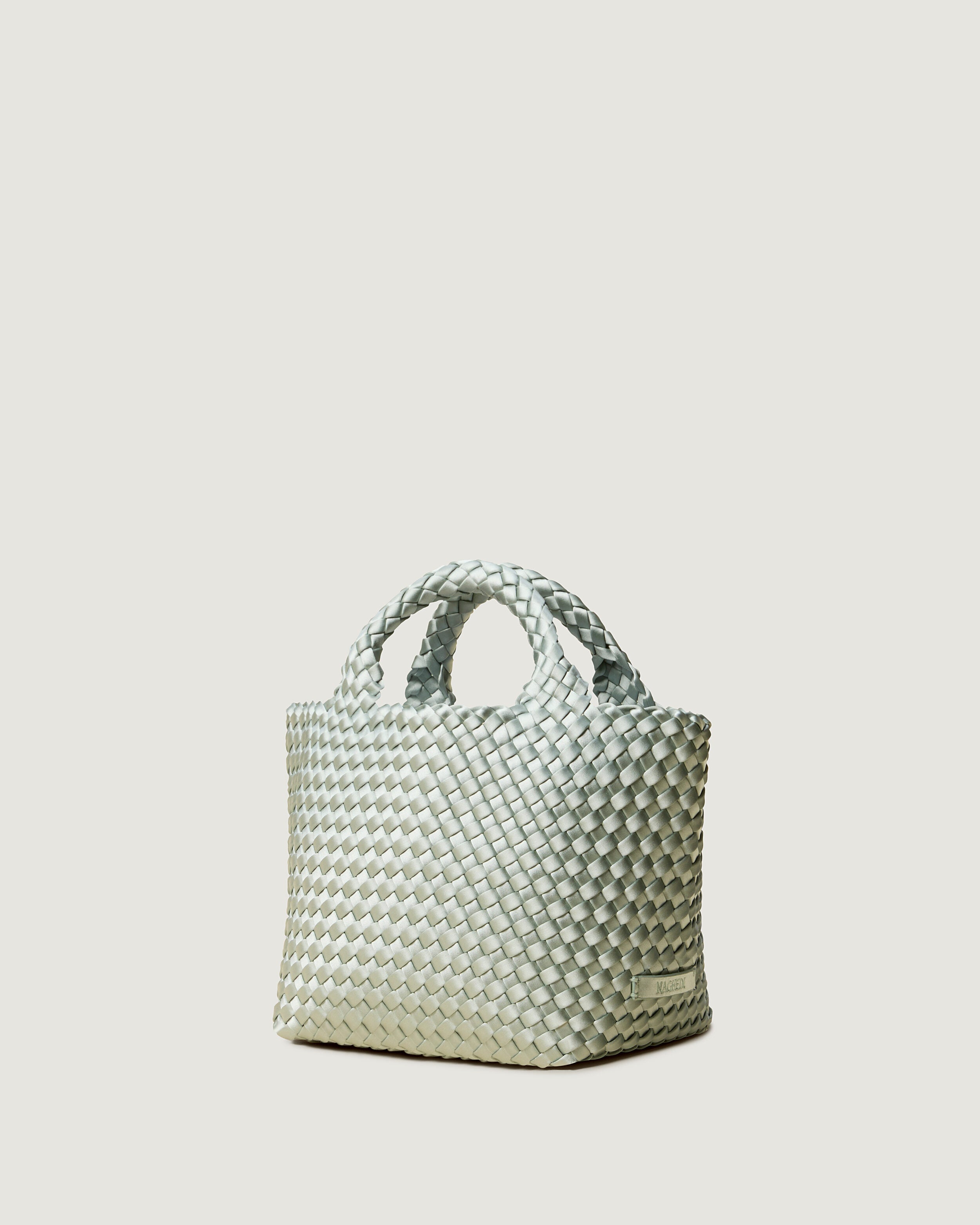 St. Barths Tote in Wintergreen shown from a side angle, highlighting its handwoven neoprene construction and open top.