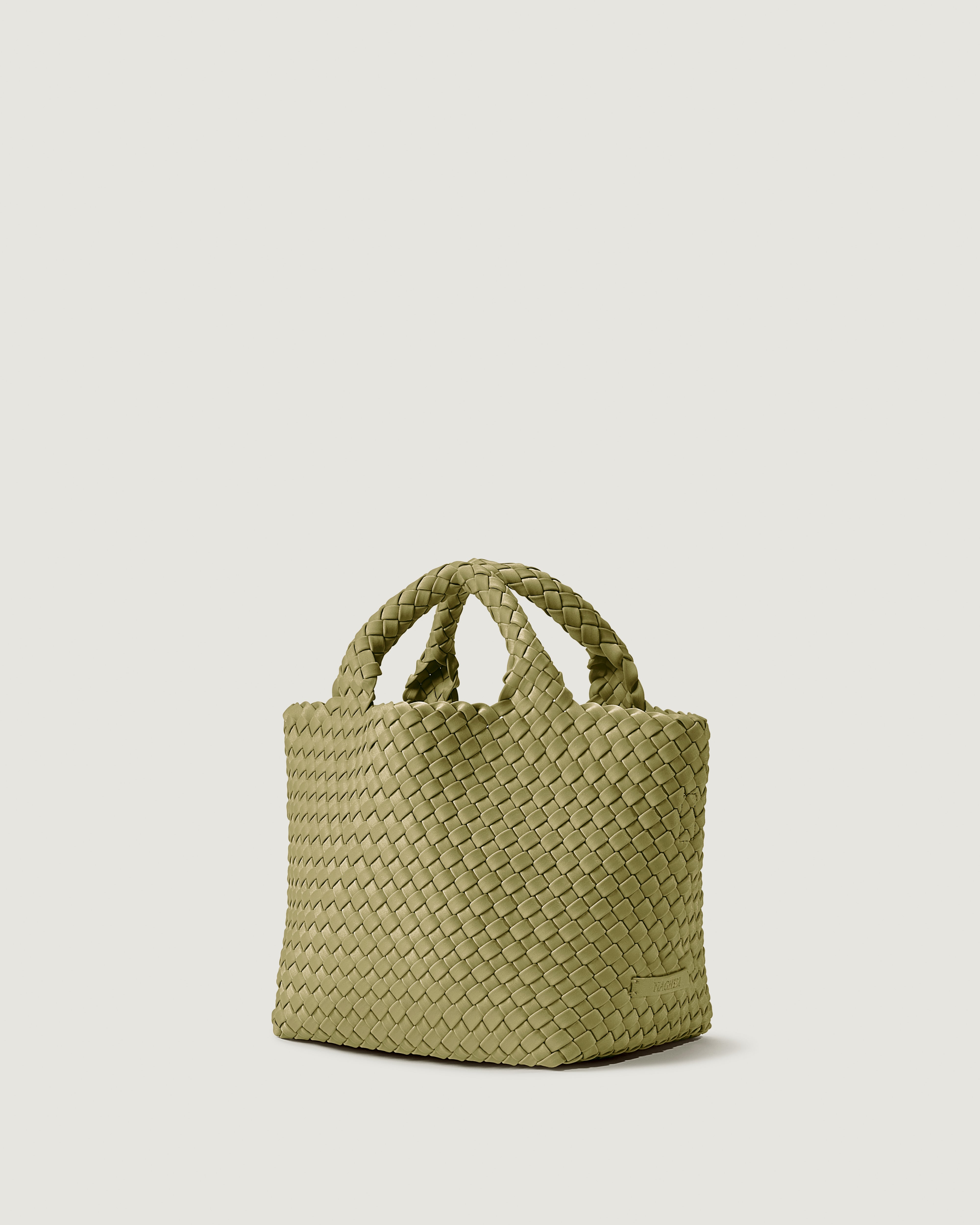 St. Barths Tote in Bottle Green shown from a side angle, highlighting its handwoven neoprene construction and open top.