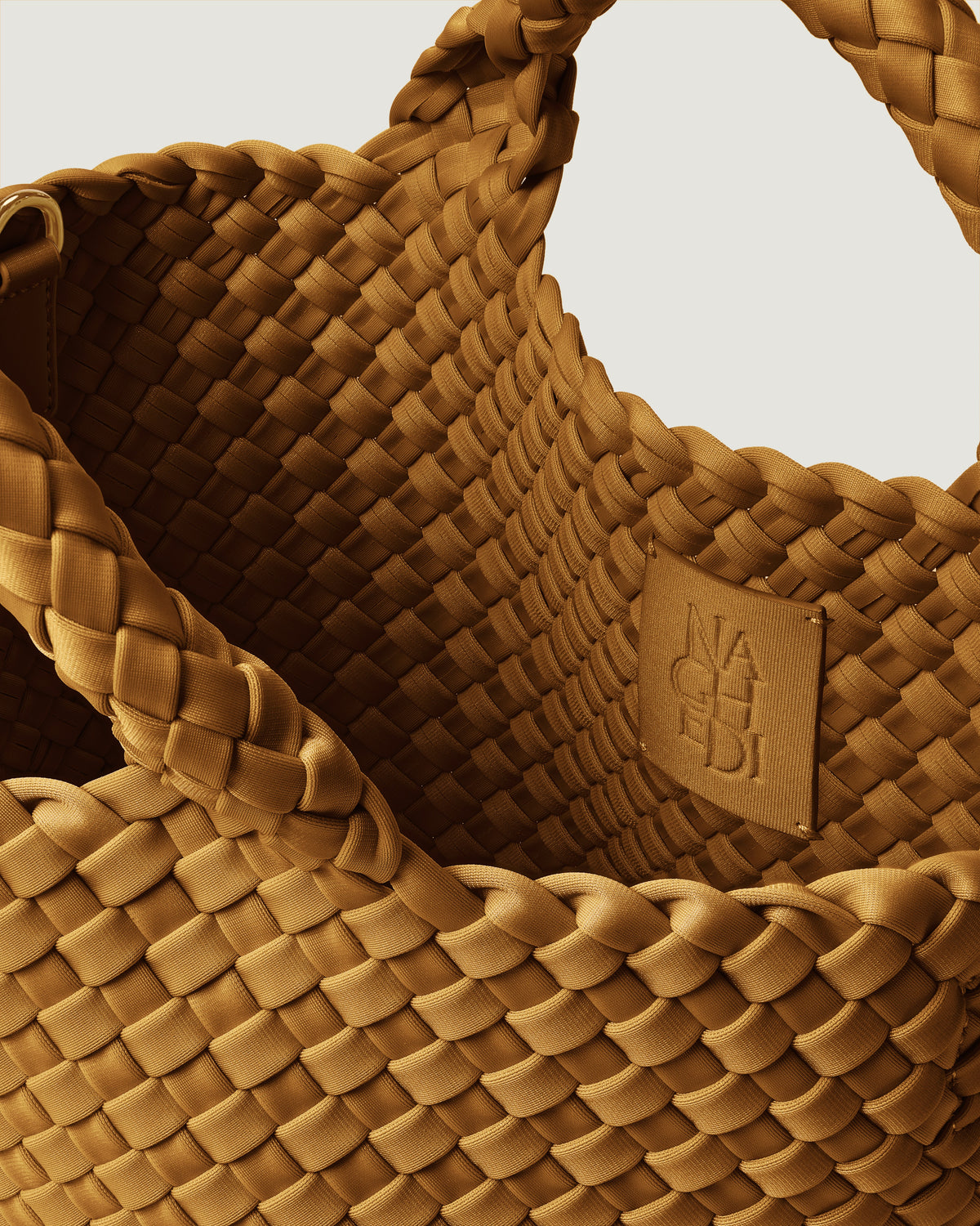 Interior close-up of St. Barths Tote in Turmeric showing its open top, and unlined interior.