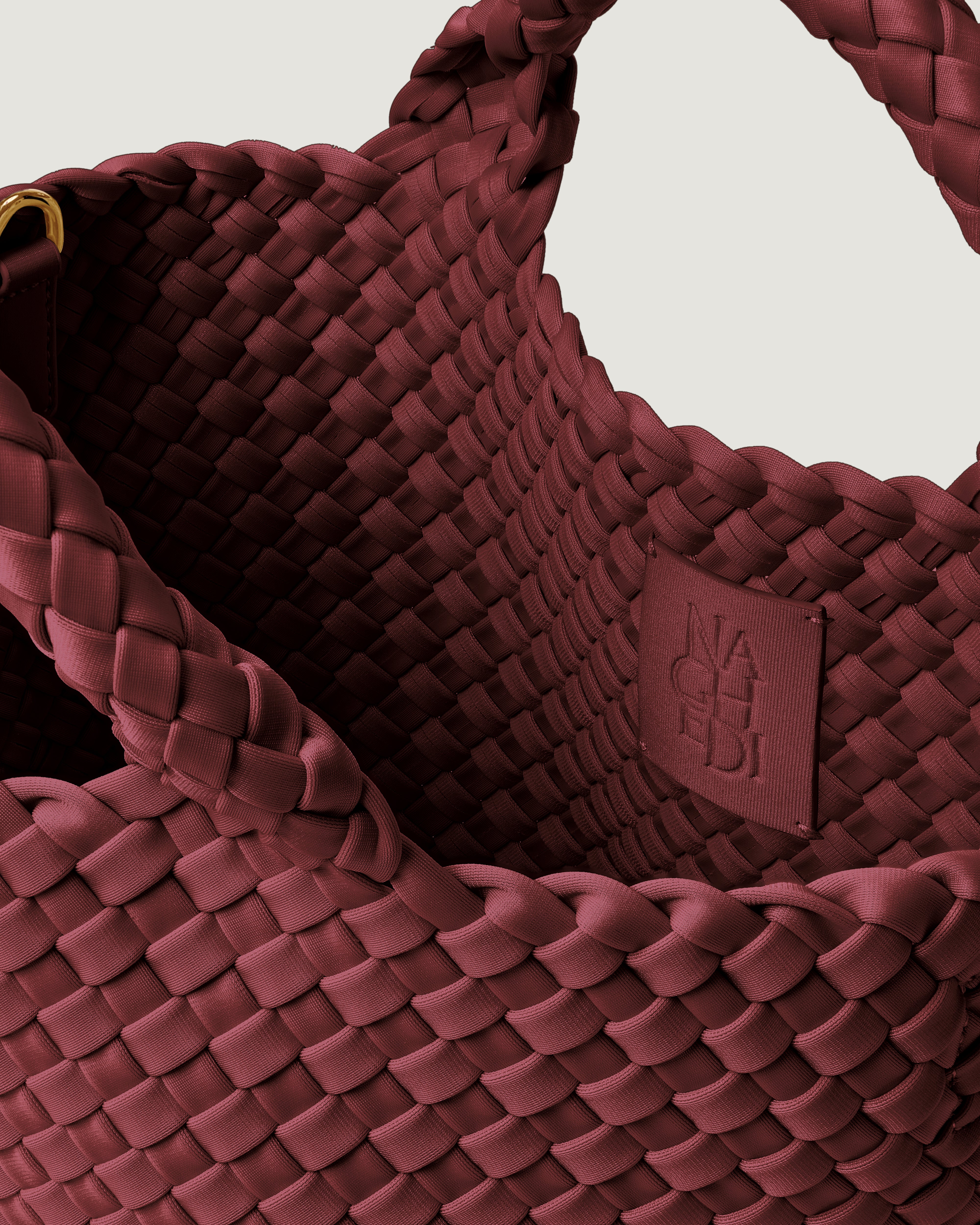 Interior close-up of St. Barths Tote in Bordeaux showing its open top, and unlined interior.