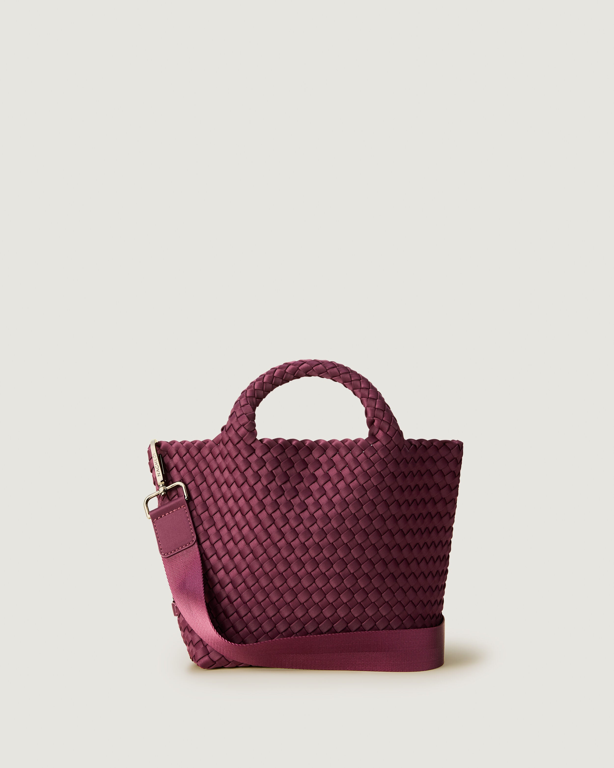 St. Barths Tote in Bordeaux, a rich burgundy tone, in handwoven neoprene, featuring an open top, woven top handles, and detachable, adjustable nylon crossbody strap.