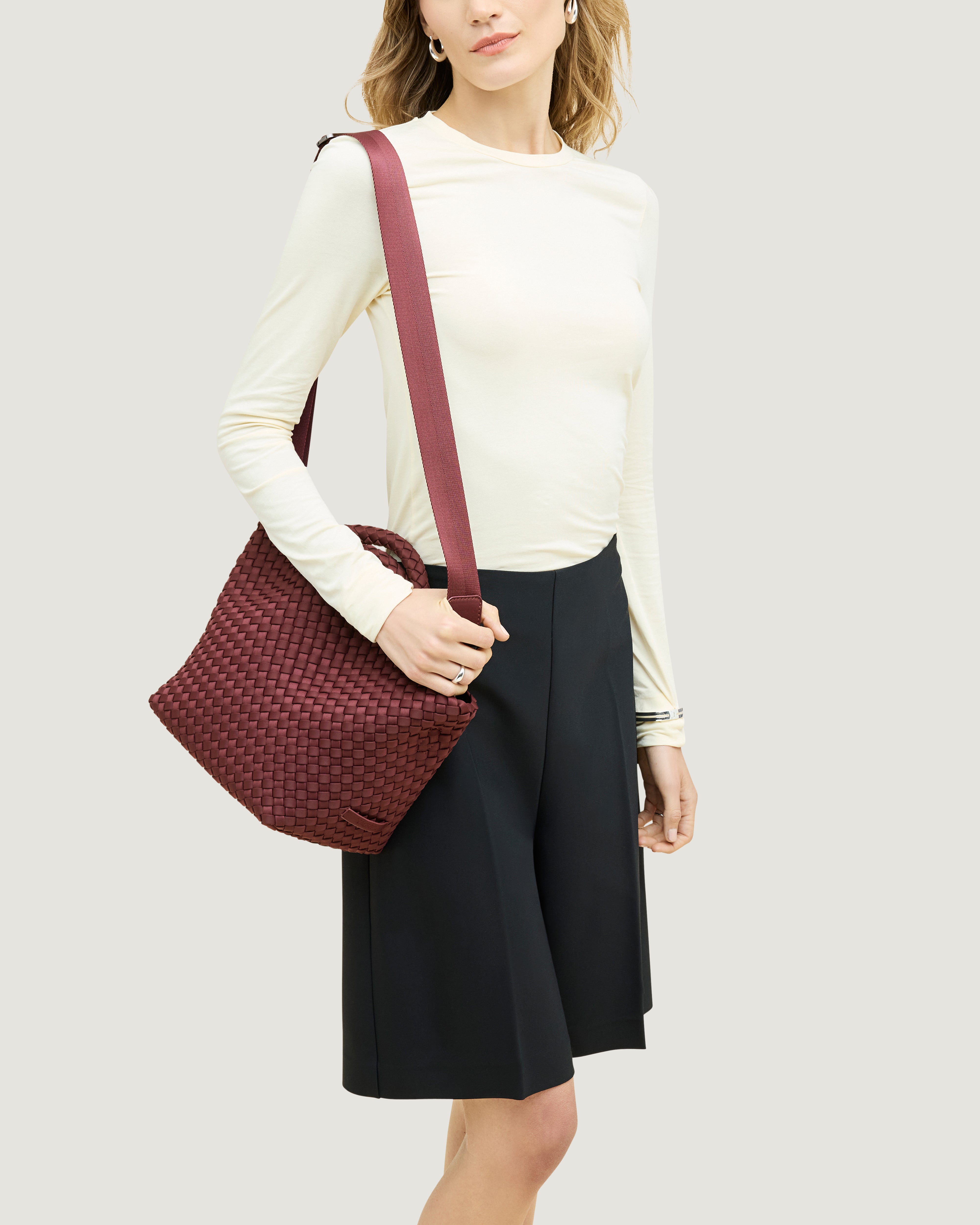 St. Barths Tote in Bordeaux shown on model to illustrate scale and soft silhouette and length of adjustable shoulder strap.