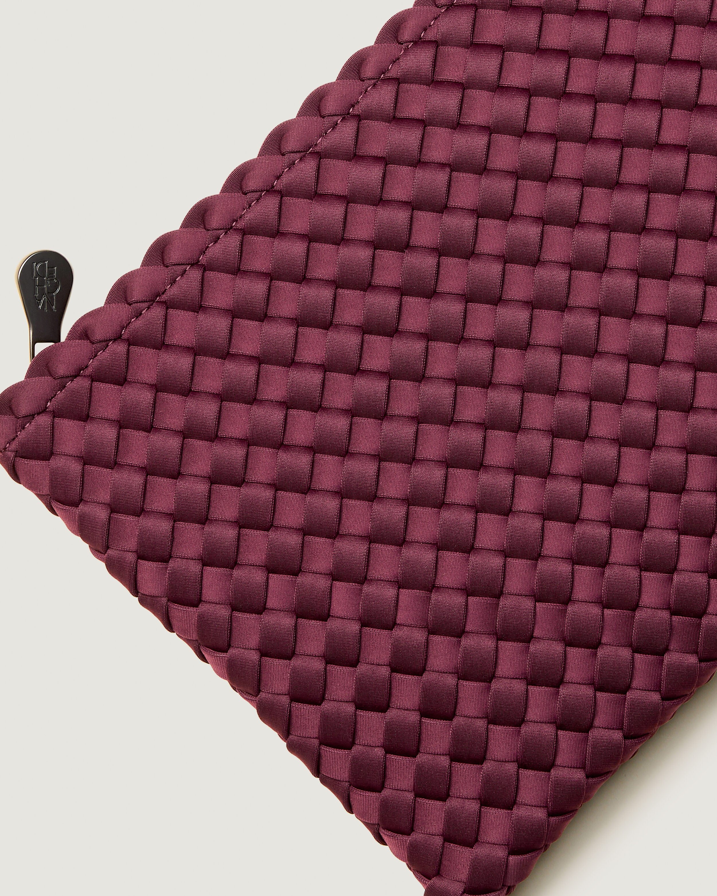 Close-up of included matching woven zippered pouch.