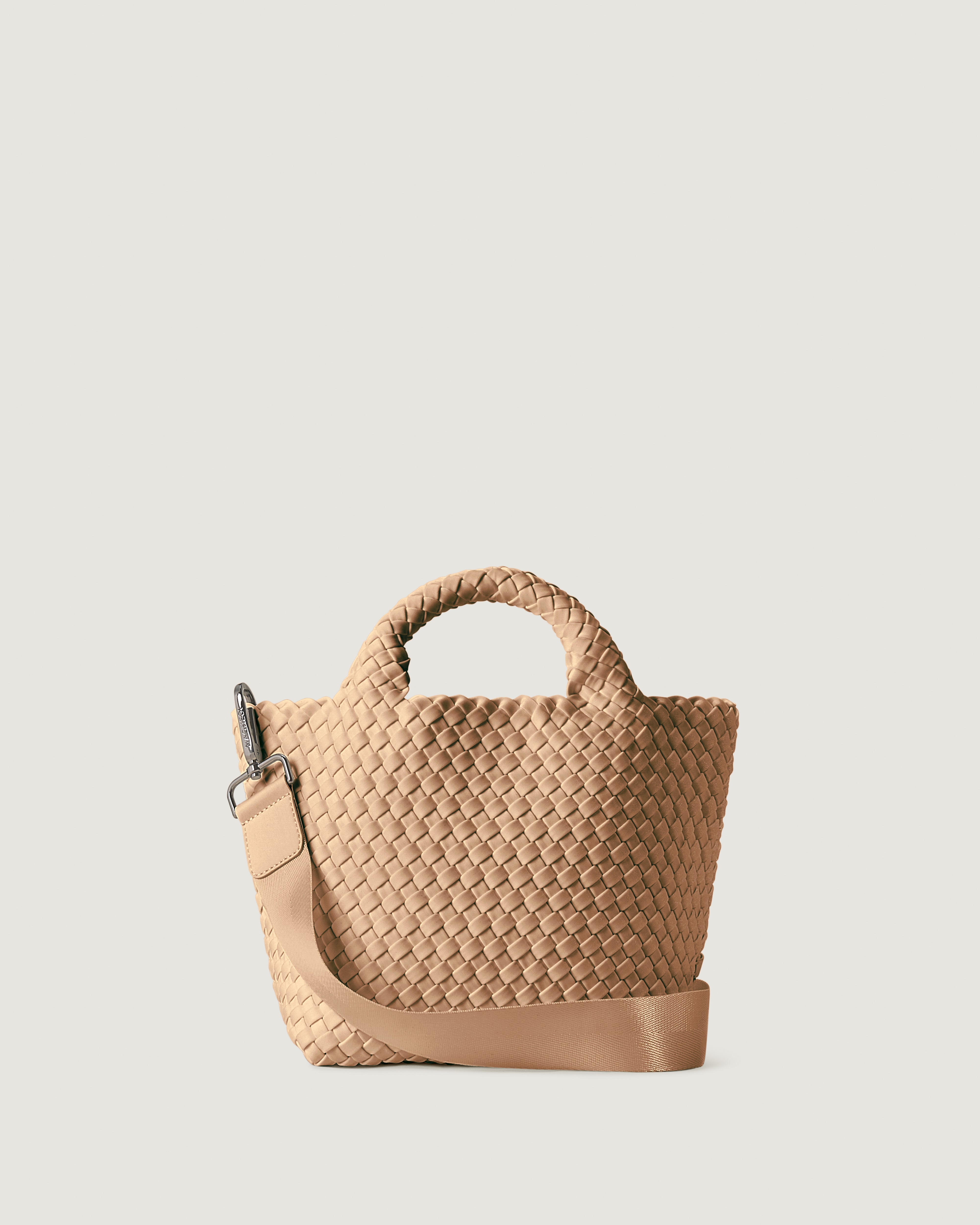 St. Barths Tote in Camel, a camel brown tone, in handwoven neoprene, featuring an open top, woven top handles, and detachable, adjustable nylon crossbody strap.