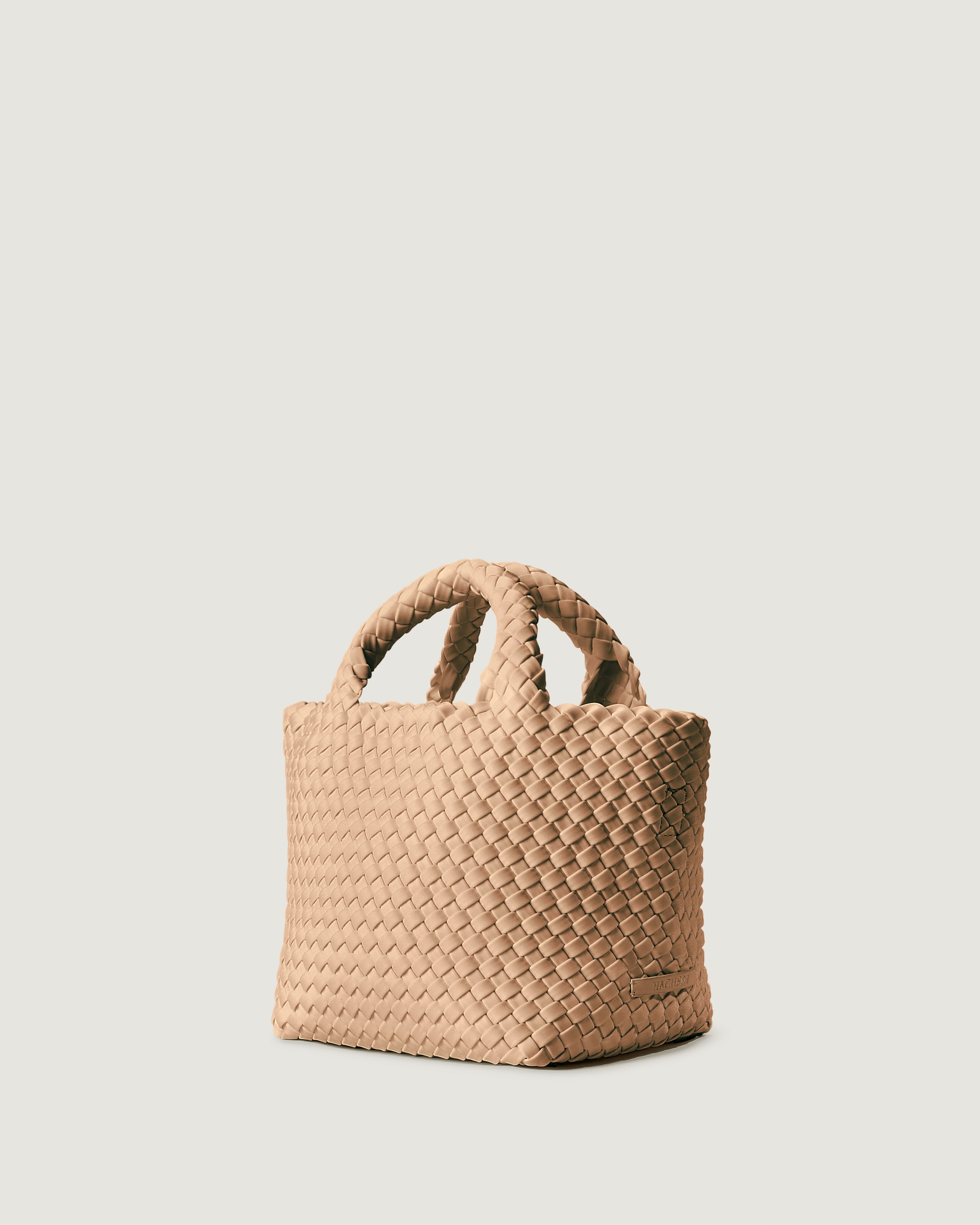 St Barths Tote in Camel shown from a side angle, highlighting its handwoven neoprene construction and open top with magnetic snap closure.