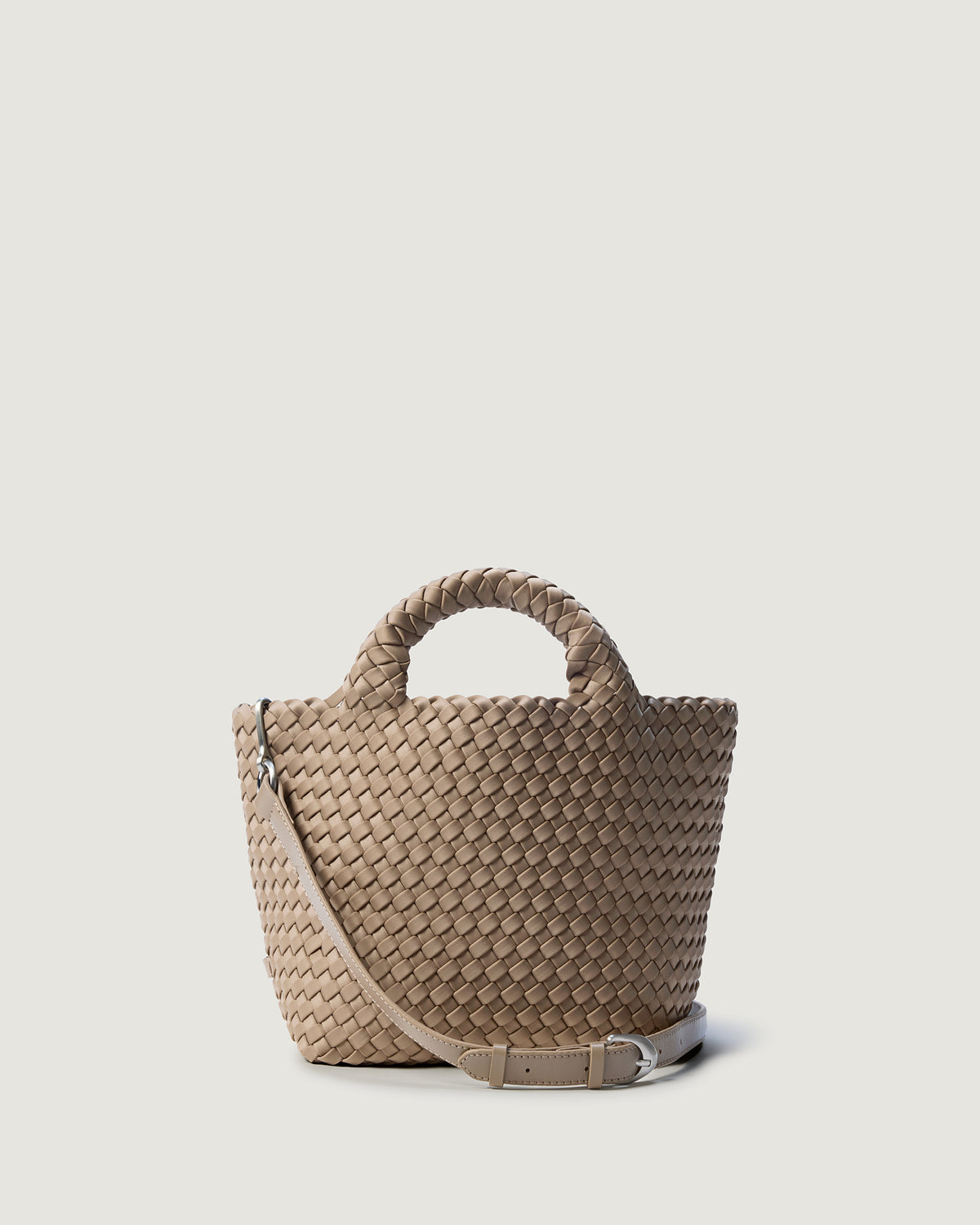 St. Barths Tote in Cashmere, a taupe tone, in handwoven neoprene, featuring a magnetic closure, woven top handles, and detachable, adjustable leather crossbody strap.