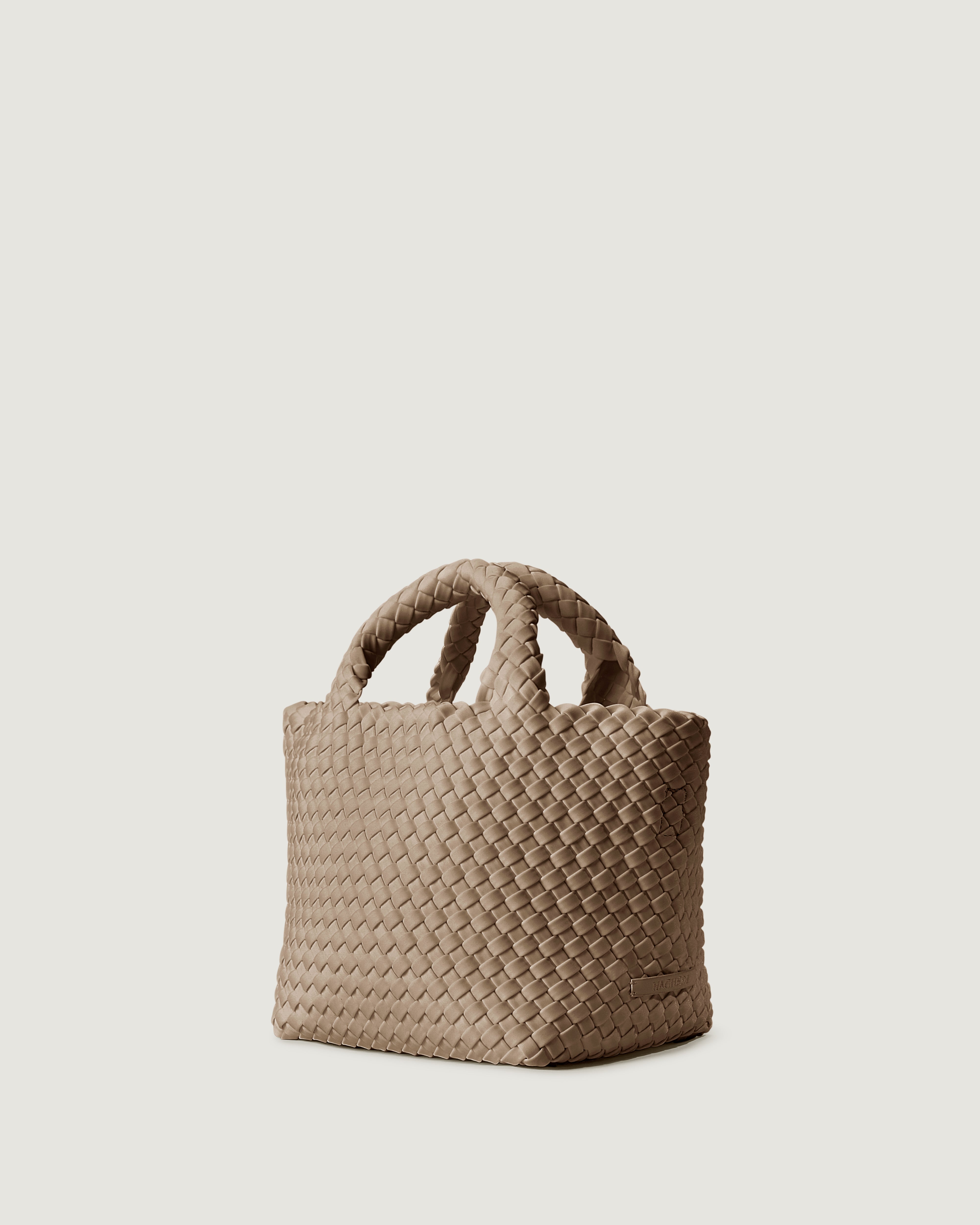 St. Barths Tote in Cashmere shown from a side angle, highlighting its handwoven neoprene construction and open top.