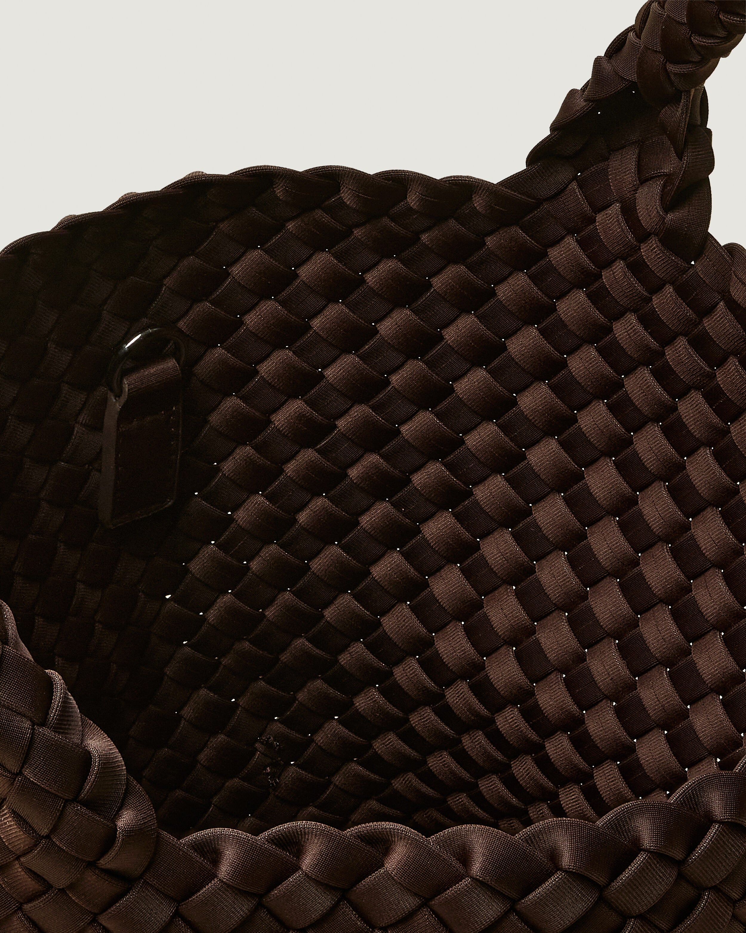 Interior close-up of St. Barths Tote in Chocolate showing its open top, and unlined interior.