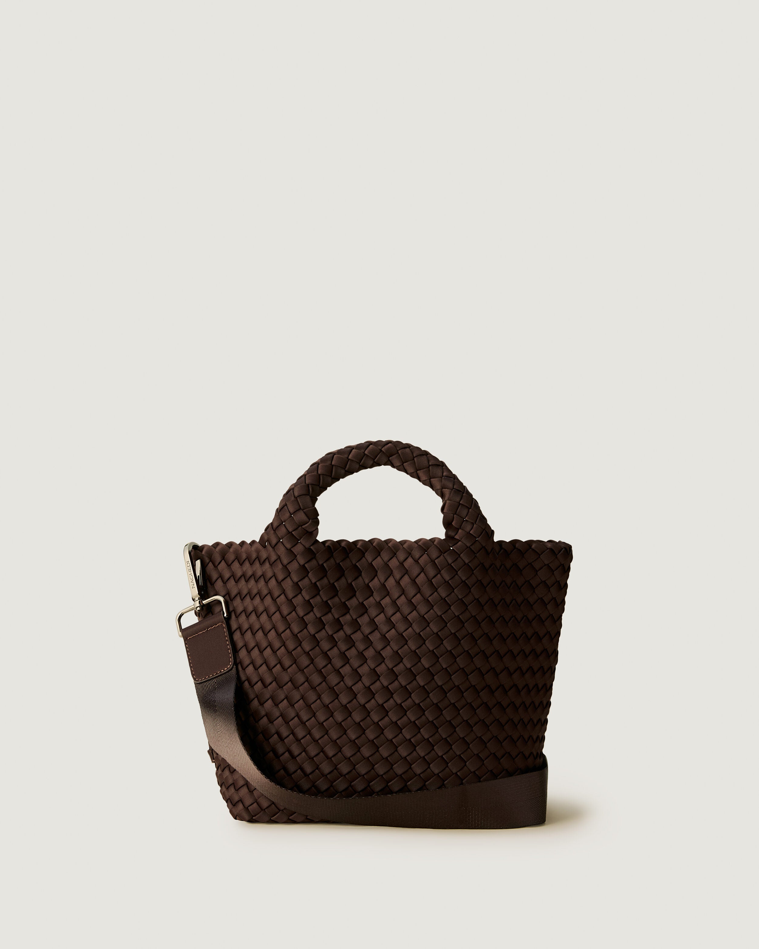 St. Barths Tote in Chocolate, a dark chocolate brown tone, in handwoven neoprene, featuring an open top, woven top handles, and detachable, adjustable nylon crossbody strap.