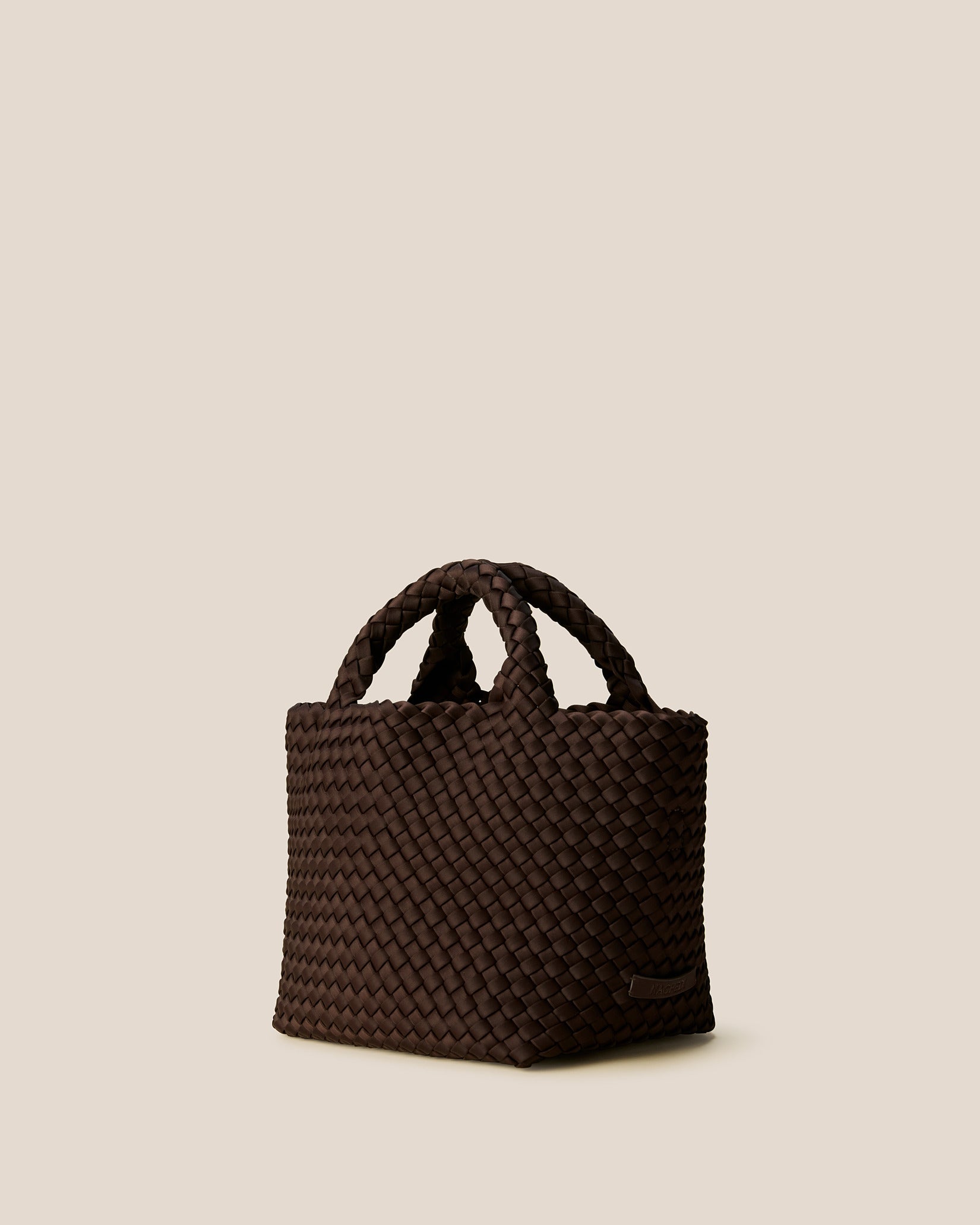 St. Barths Small Tote Bag in Chocolate shown from a side angle, highlighting its handwoven neoprene and open top.