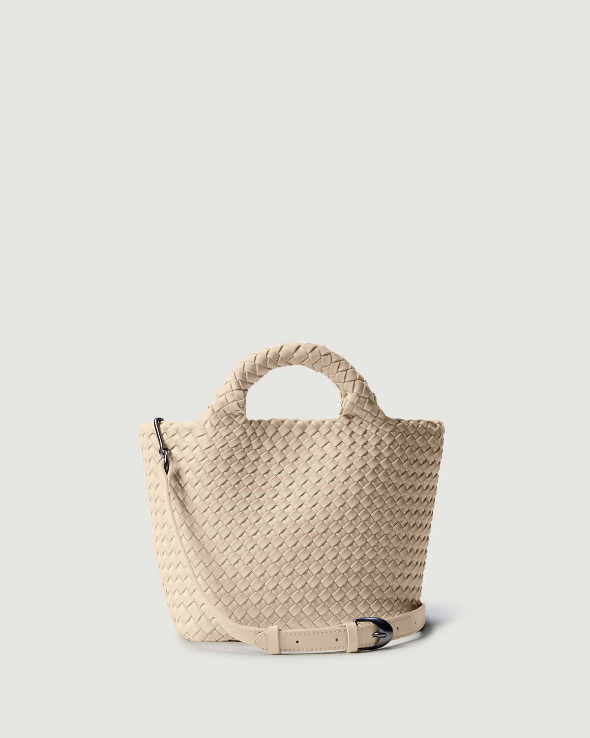 St. Barths Tote in Ecru in handwoven neoprene, featuring a magnetic closure, woven top handles, and detachable, adjustable leather crossbody strap.