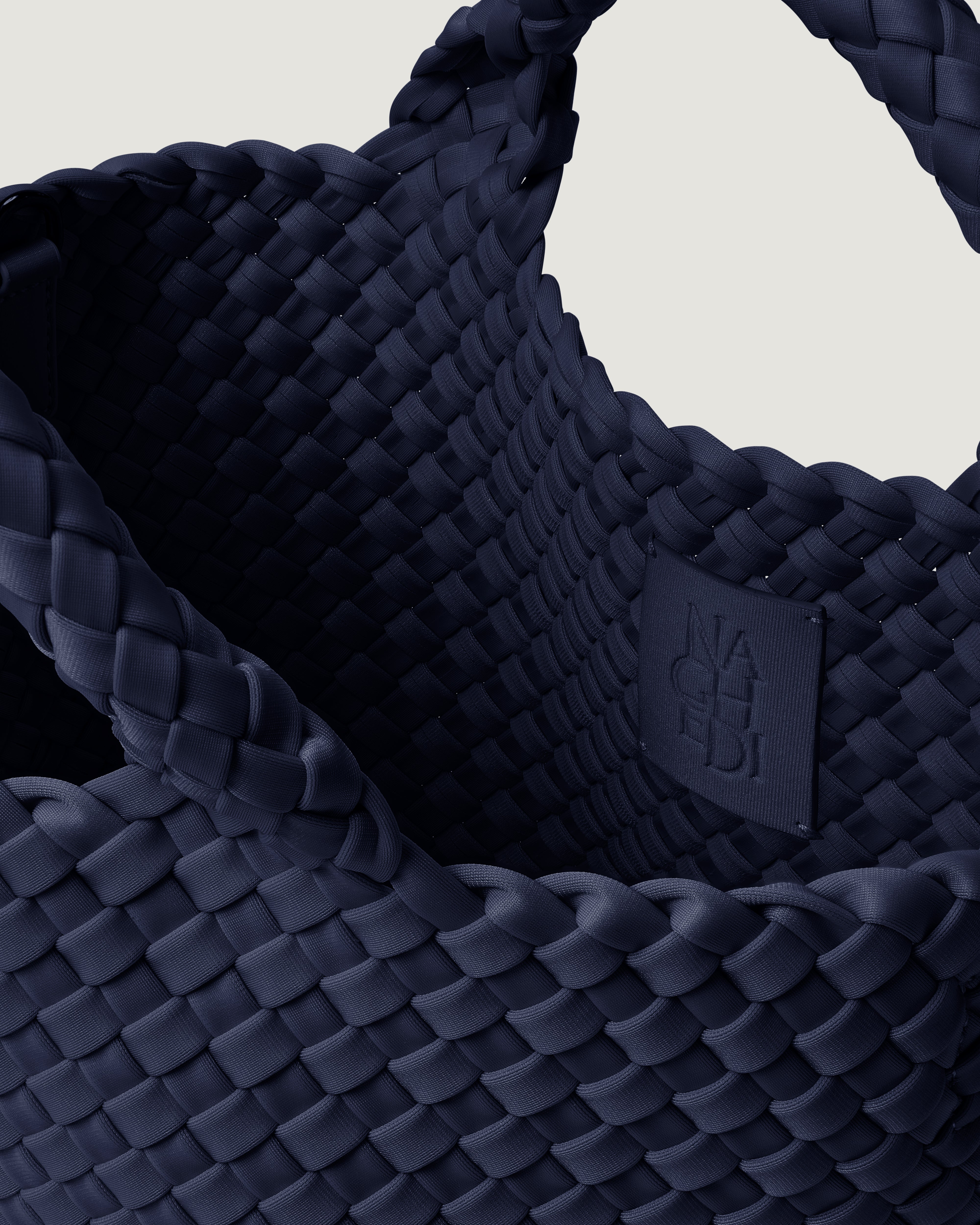 Interior close-up of St. Barths Tote in Ink Blue showing its magnetic closure, and unlined interior.
